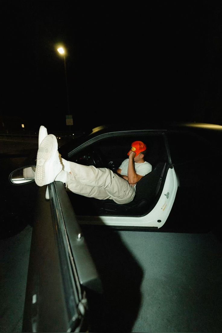 A thoughtful young person with dark hair gazes to the side, captured in soft black and white lighting.