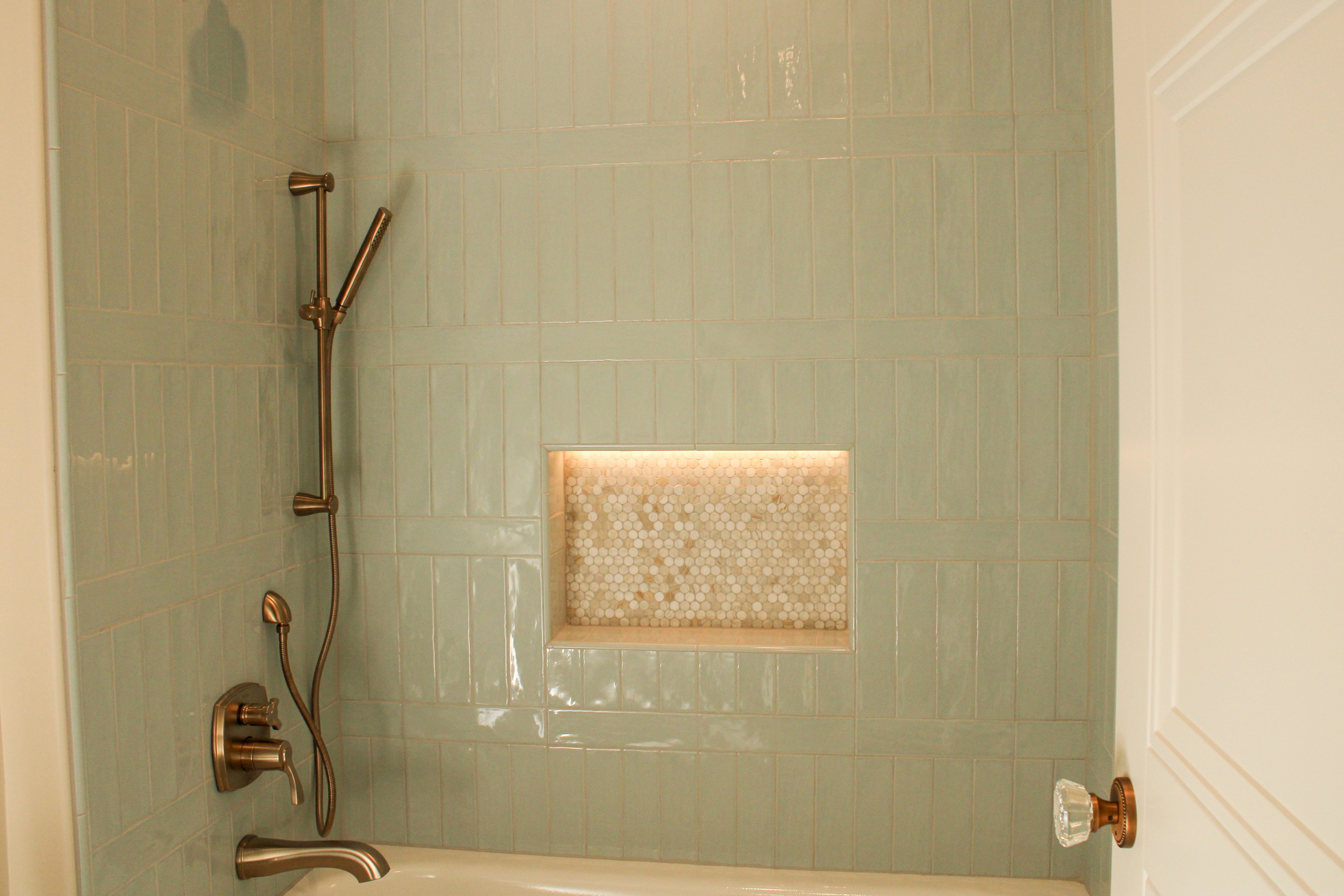 Tiled bathroom with an built-in shower niche and elegant finishes in a St. George, Utah custom home.