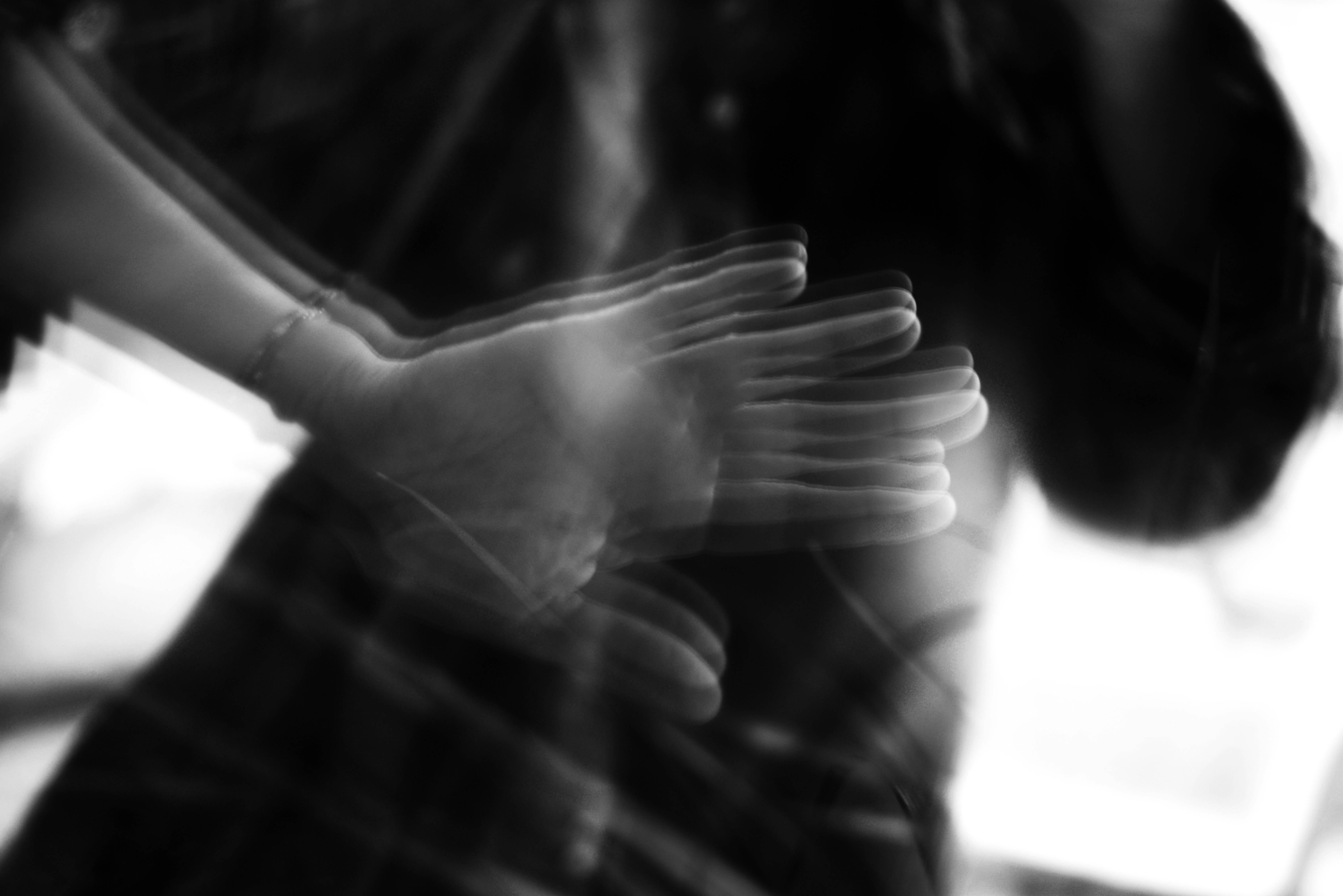 Blurred hands moving in a dark setting