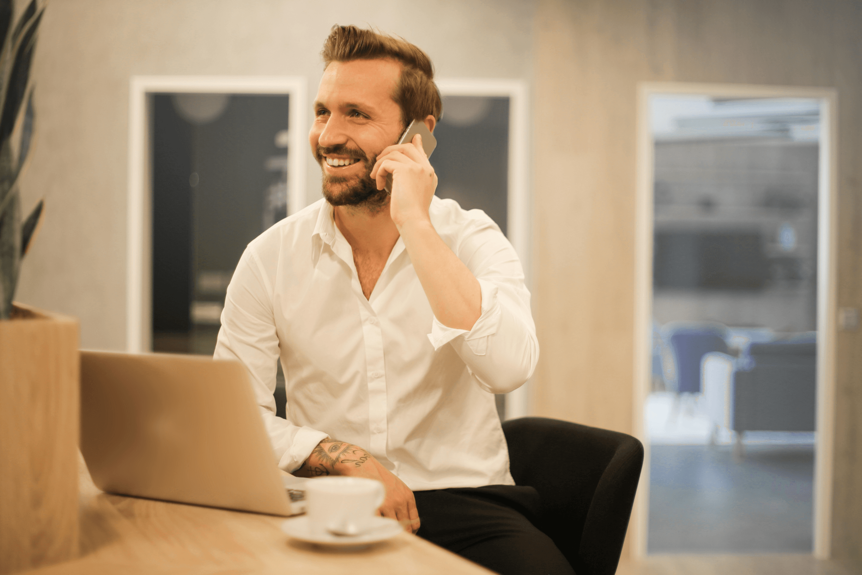 Man talking on the phone, smiling.