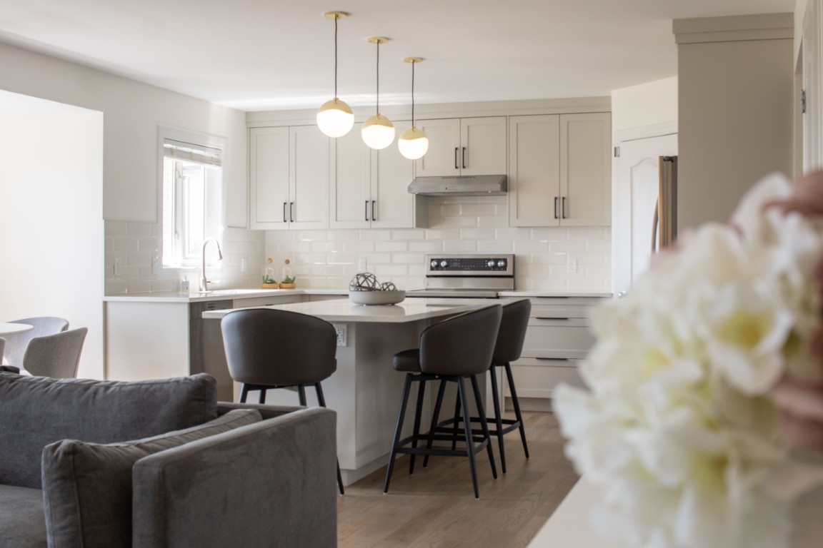 Image of Modern kitchen with island seating and white cabinetry designed by KHD Homes for luxury home renovations.