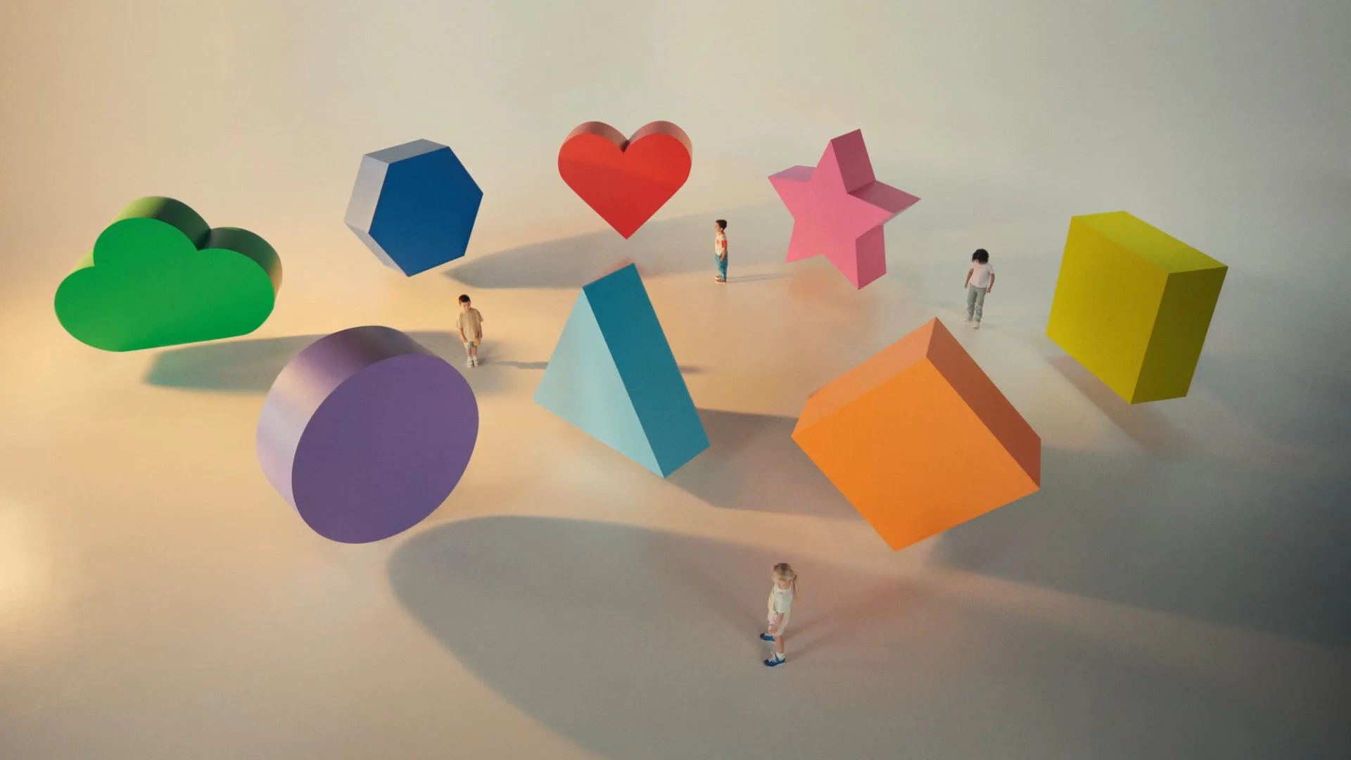 Oversized coloured 3D shapes with small children among them, from the Free Kinder 'You can shape young lives' campaign