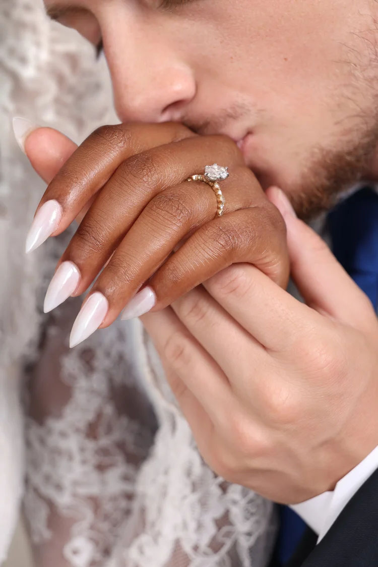 Close-up of a couple holding hands and kissing