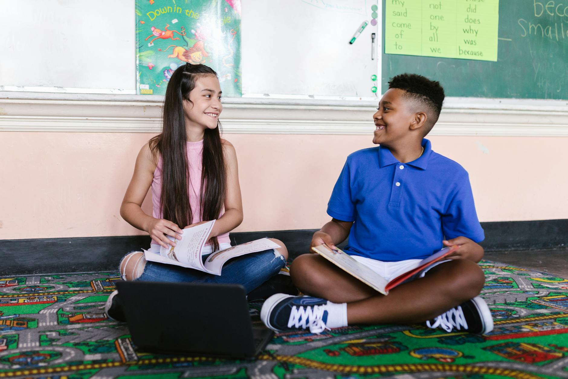 Colorful hand-drawn classroom posters showing positive behavior icons like listening ears and kind hands.