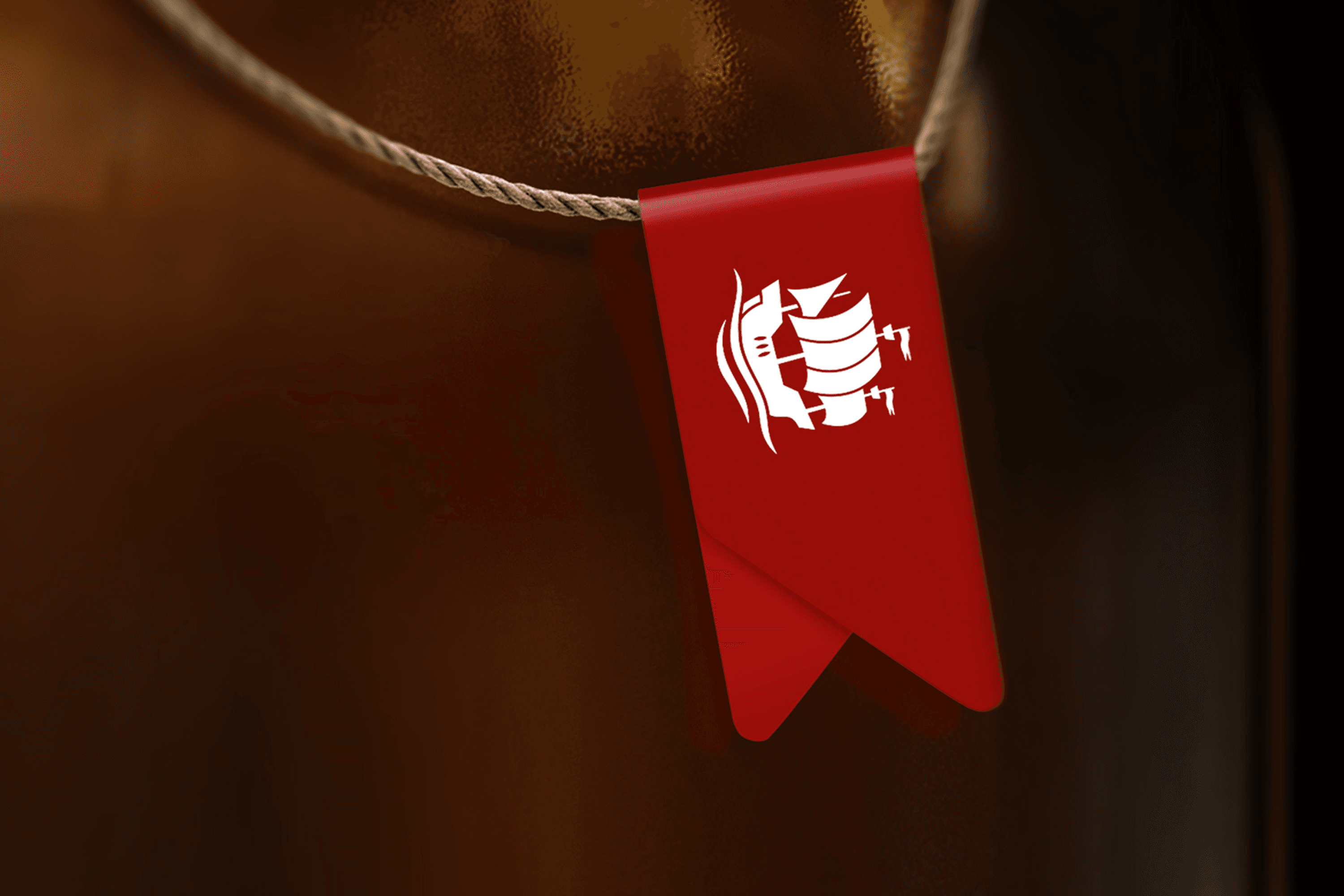 Red tag with white sailing ship logo on string
