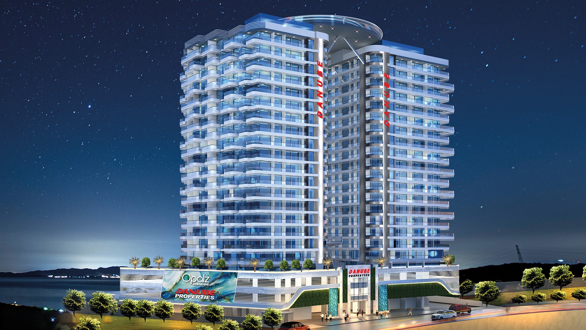 A nighttime view of the new hotel in Danube Shahrukhz, highlighting its glowing exterior and modern architectural design.