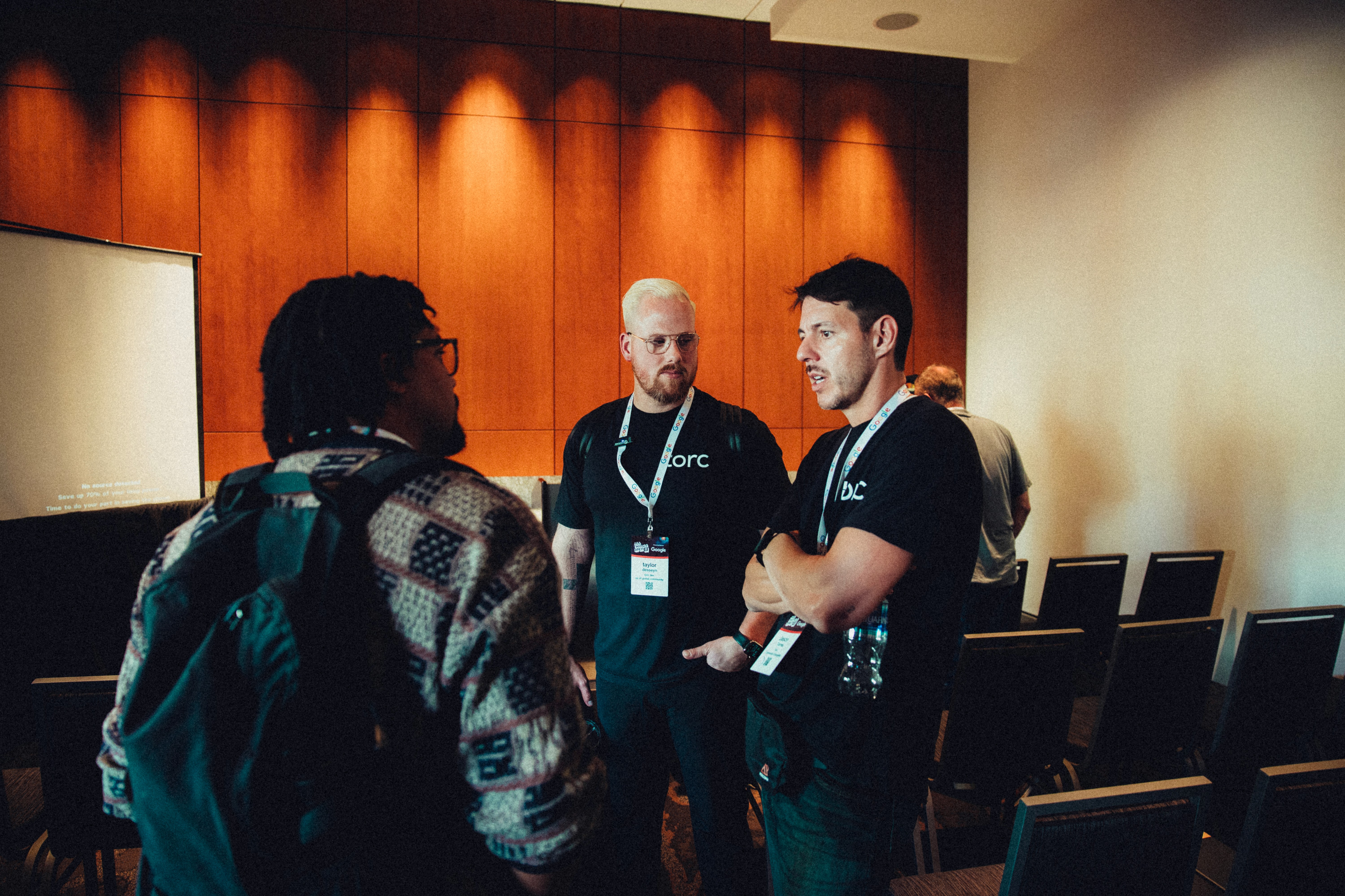 person holding pencil near laptop computer