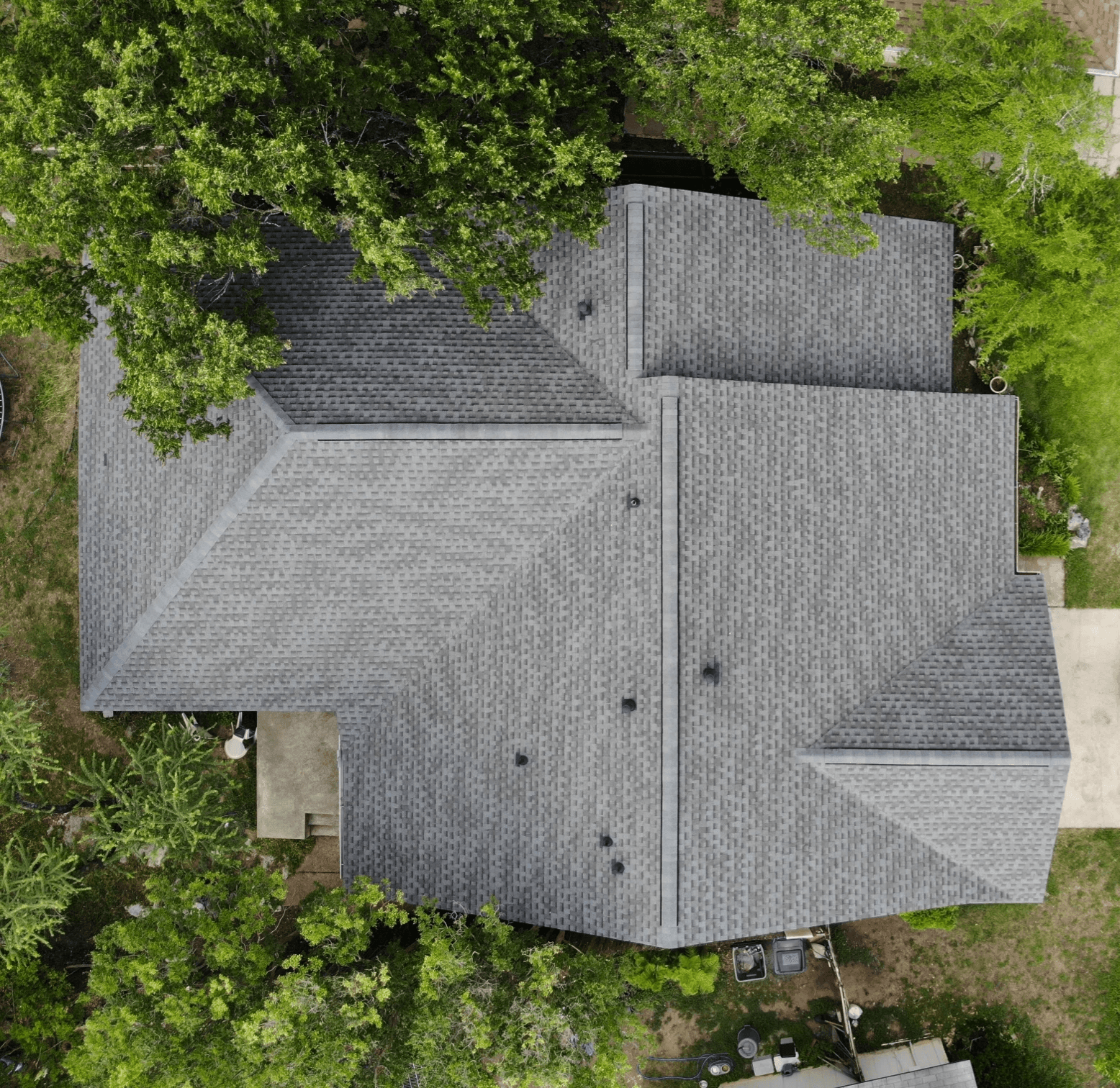 Crossed hip roof with GAF architectural shingles and a ridge vent, combining stylish design and enhanced attic ventilation.