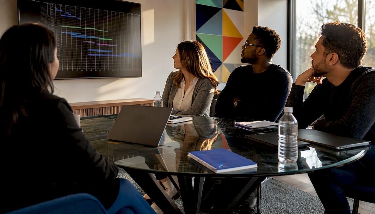 Diverse team planning cloud migration waves in meeting room