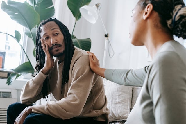 Woman comforting a man that seems down