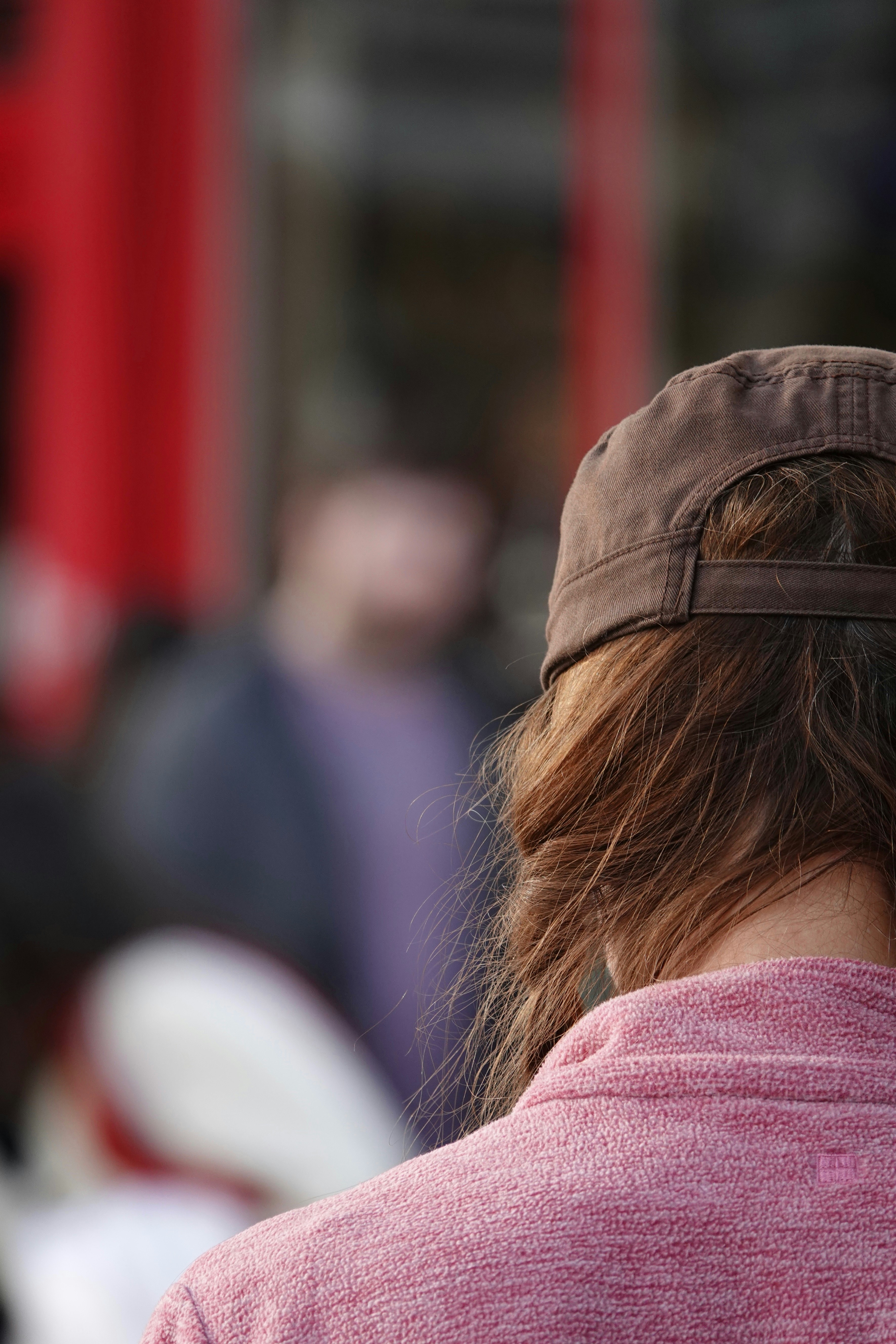 A person is looking away, blurred background