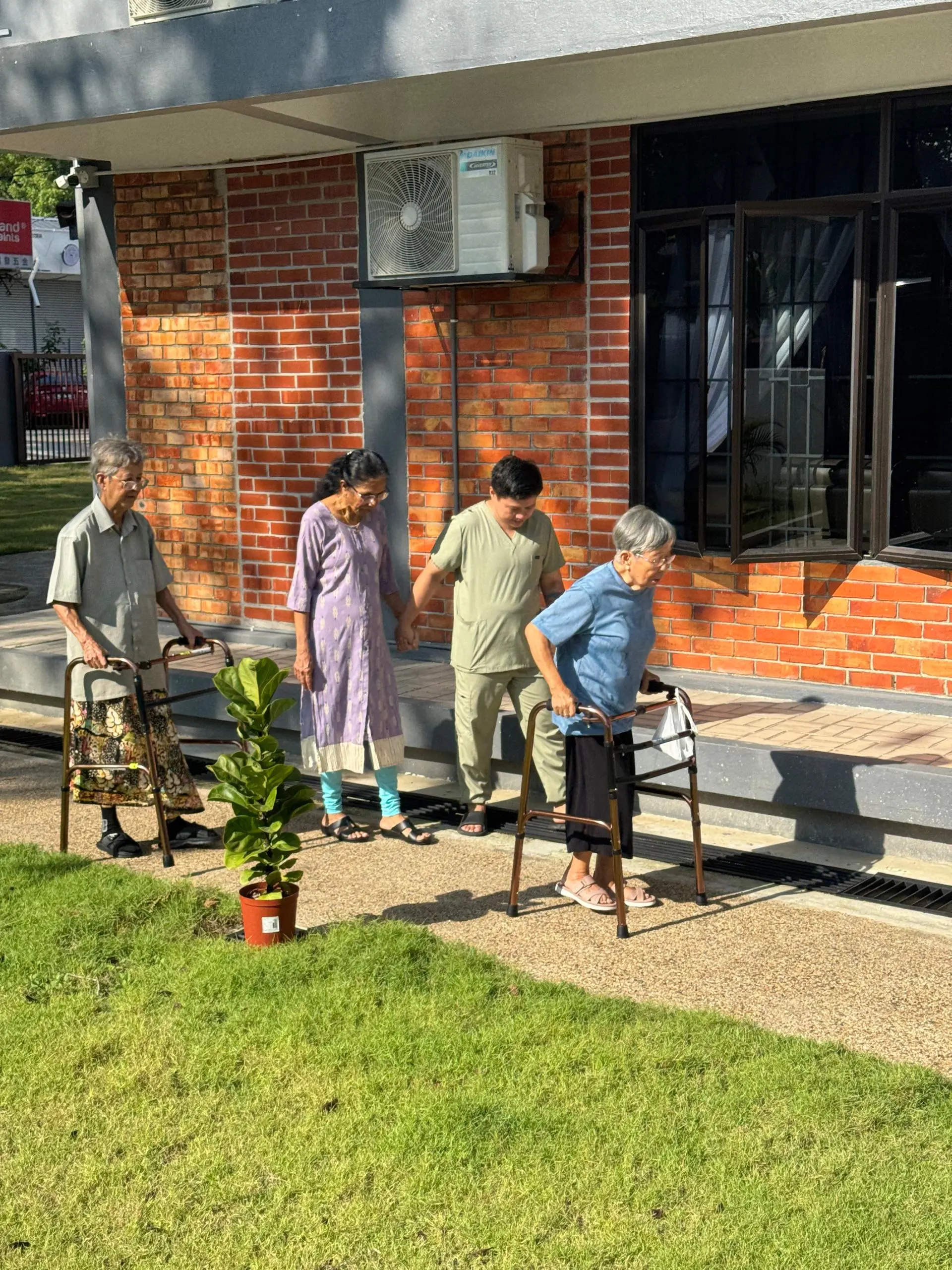 Golden Oak's residents having a walk in the garden at Golden Oaks nursing home.
