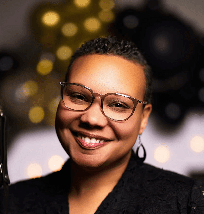A woman smiling while working at a computer