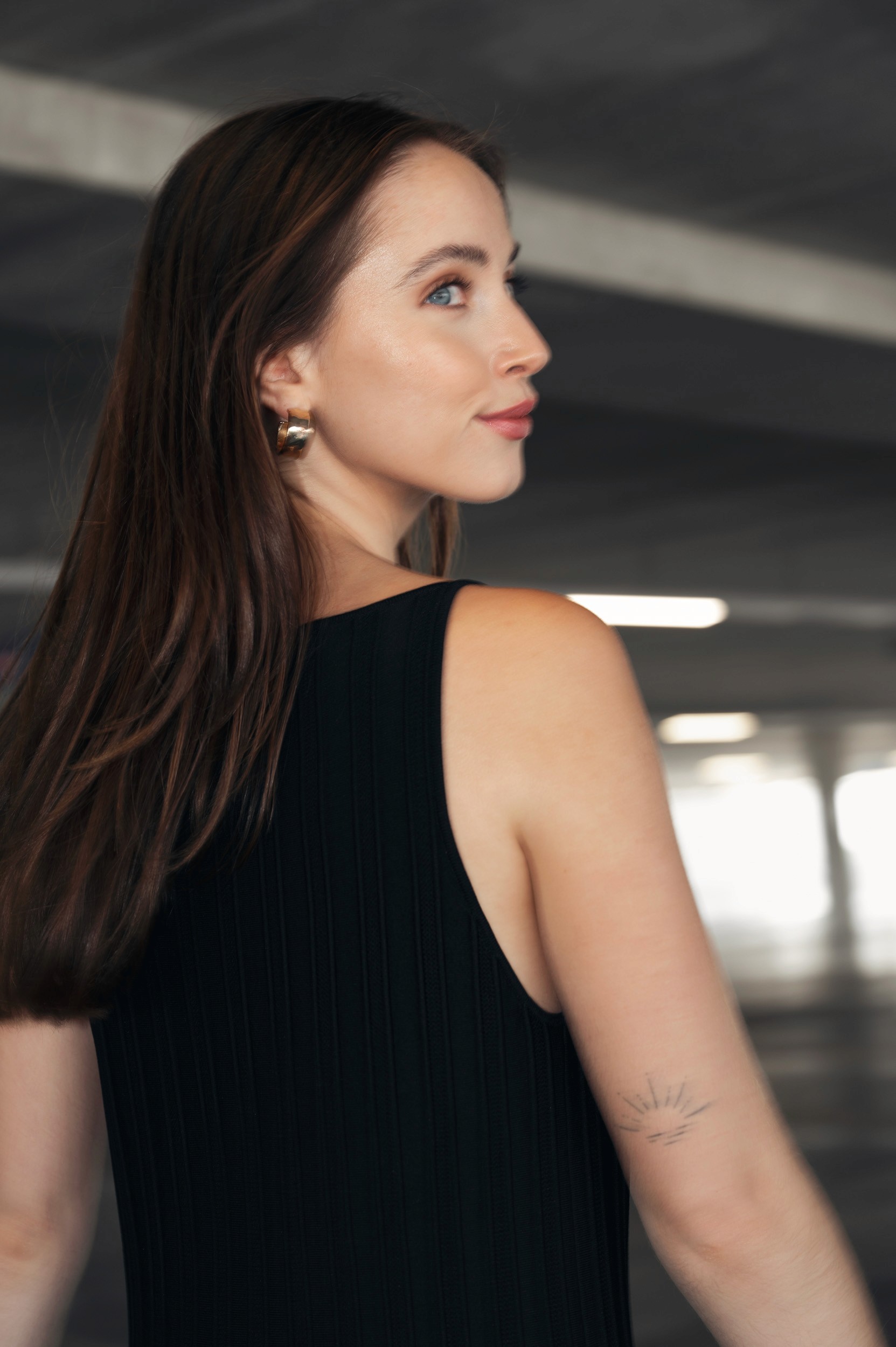 Woman in bathrobe holding champagne glass on bed.