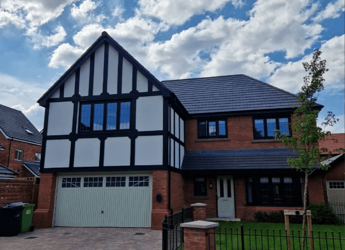 A big home with a garage victorian style pillars