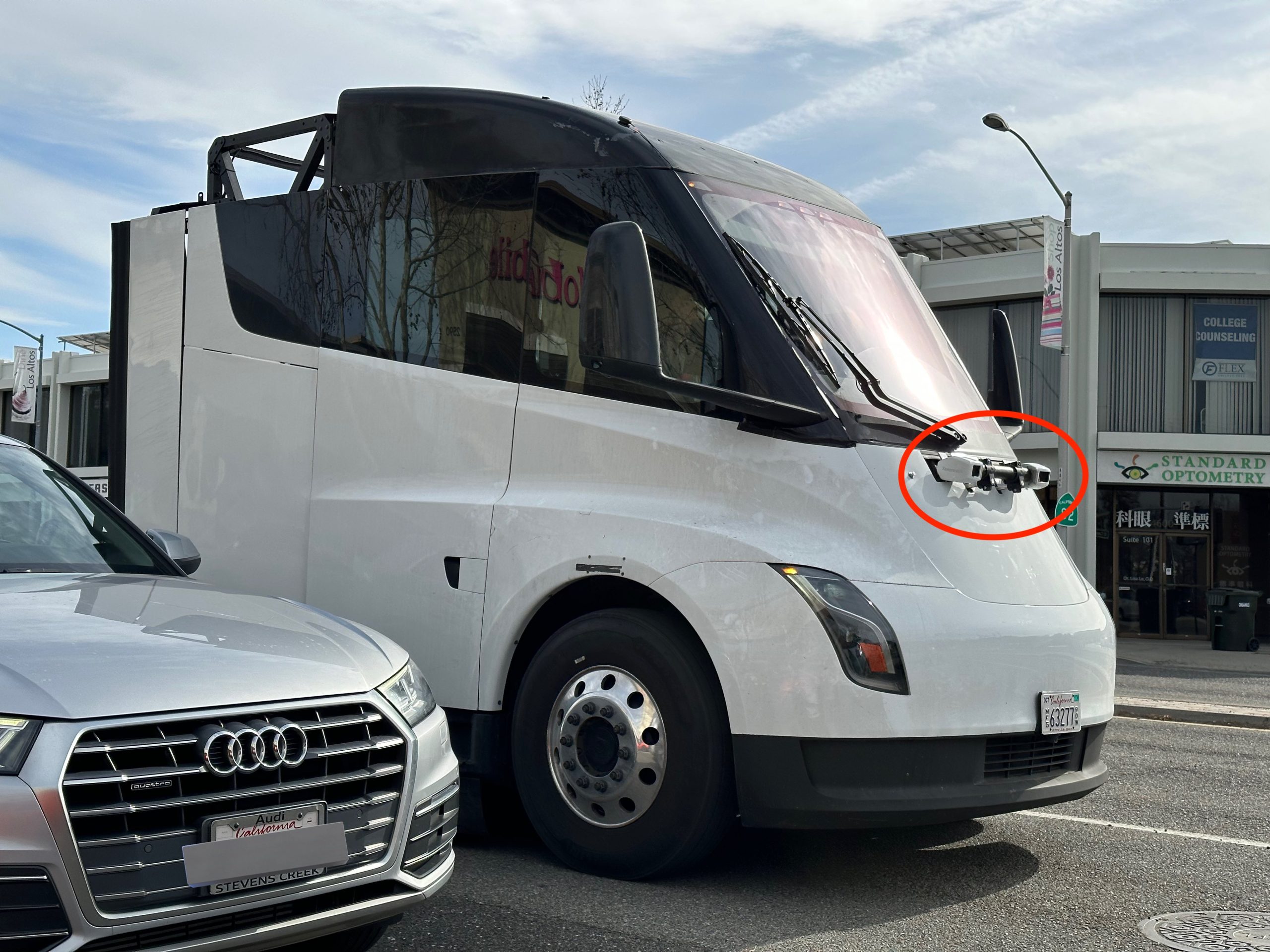 A truck using telematics and autonomous driving systems on a highway, symbolizing technology adoption in the trucking industry.