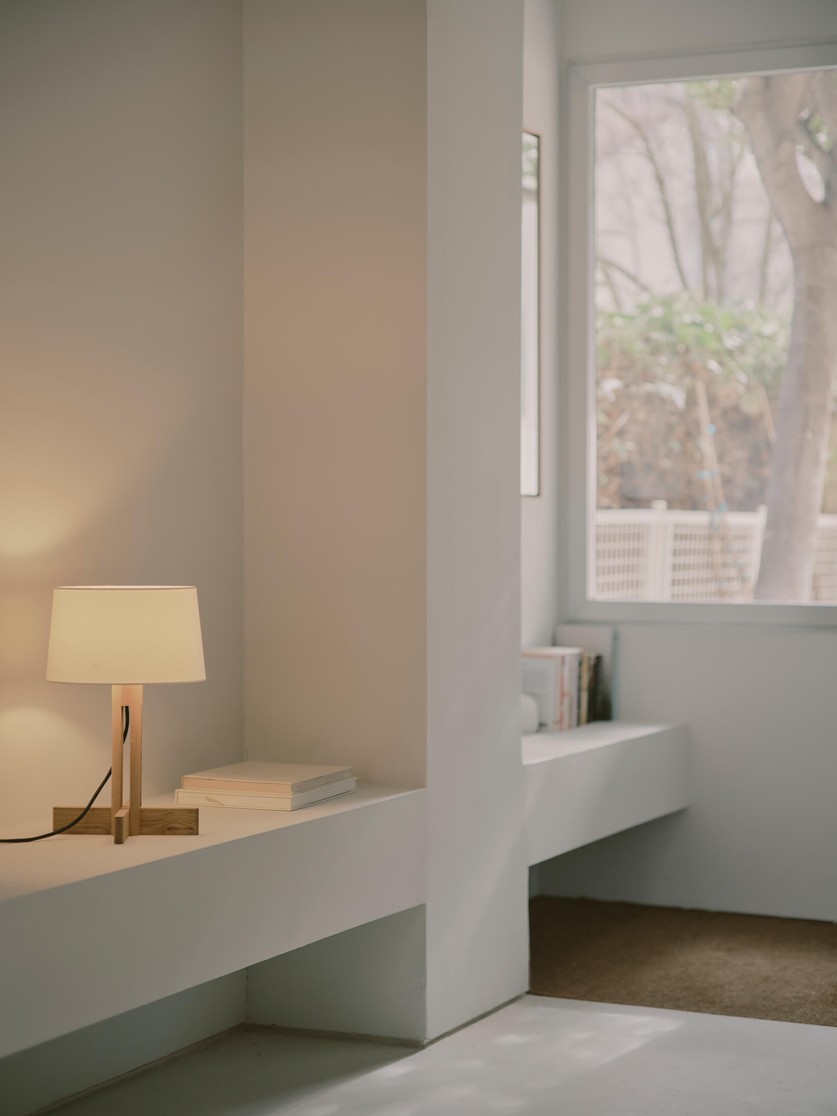 Minimal bedside table with warm ambient lamp