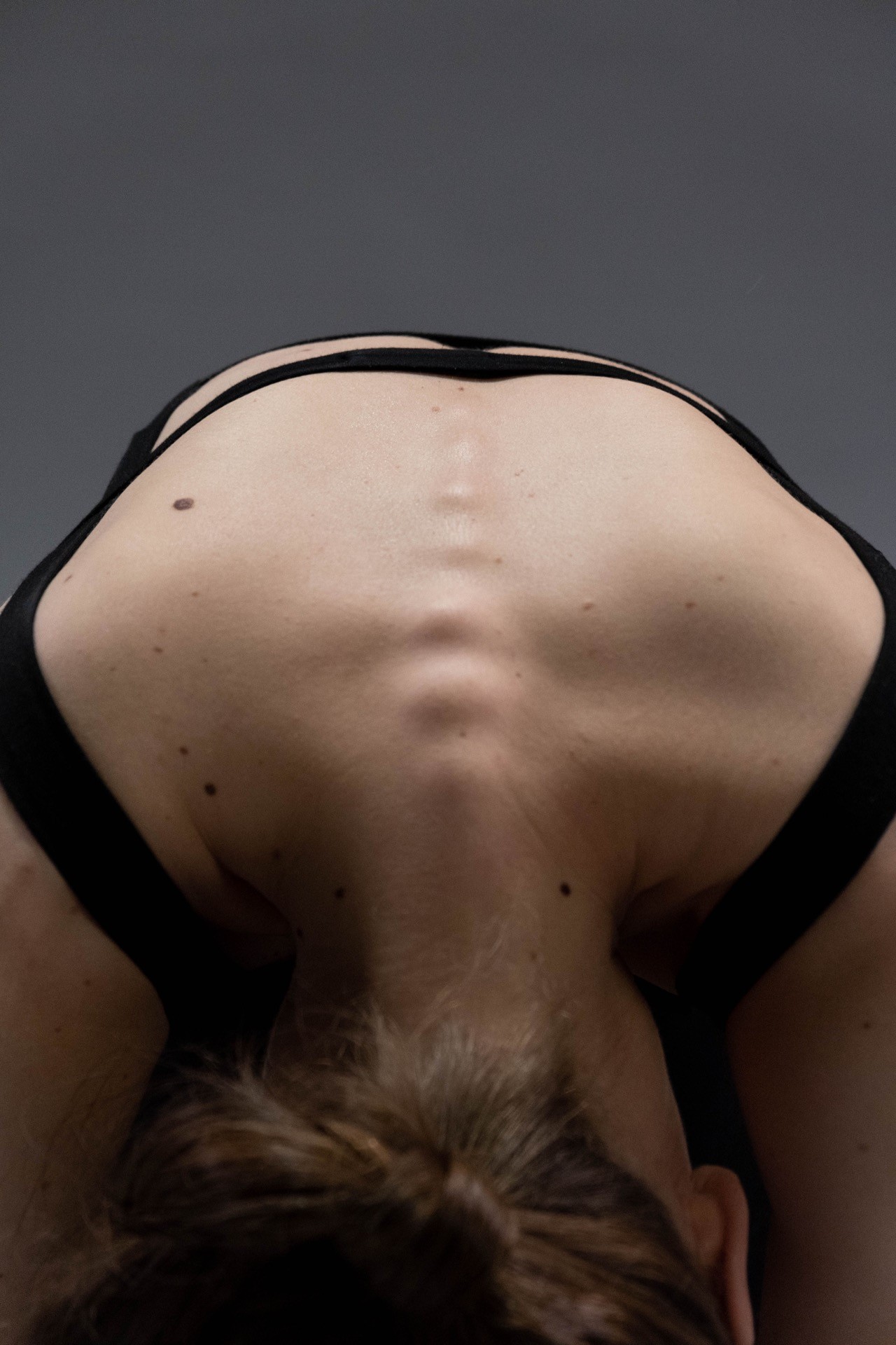 Wild Chiropractic brand photograph of a person bending forward