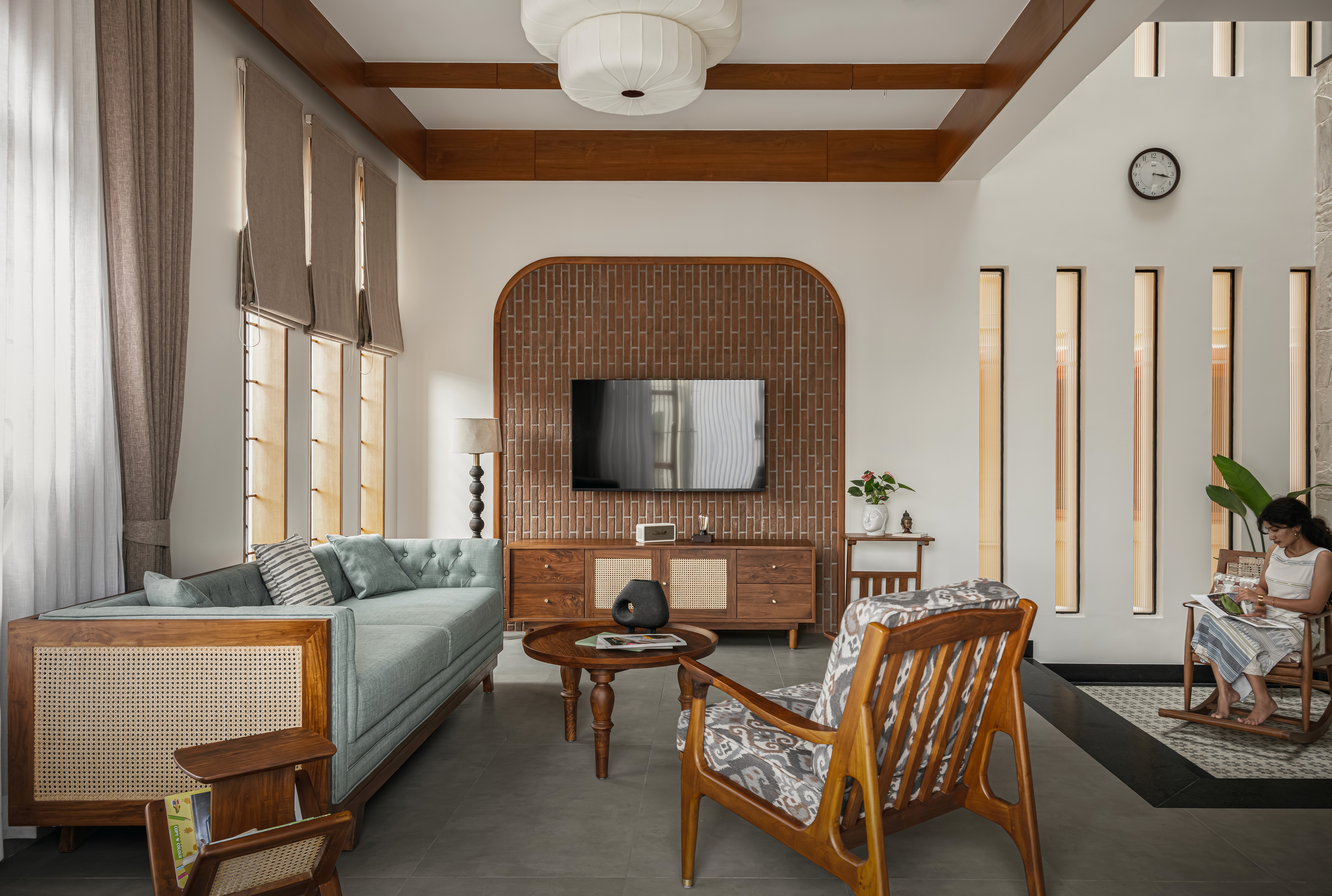 Futuristic glass skyscraper with a bold angular design, reflecting the surrounding city skyline at dusk.