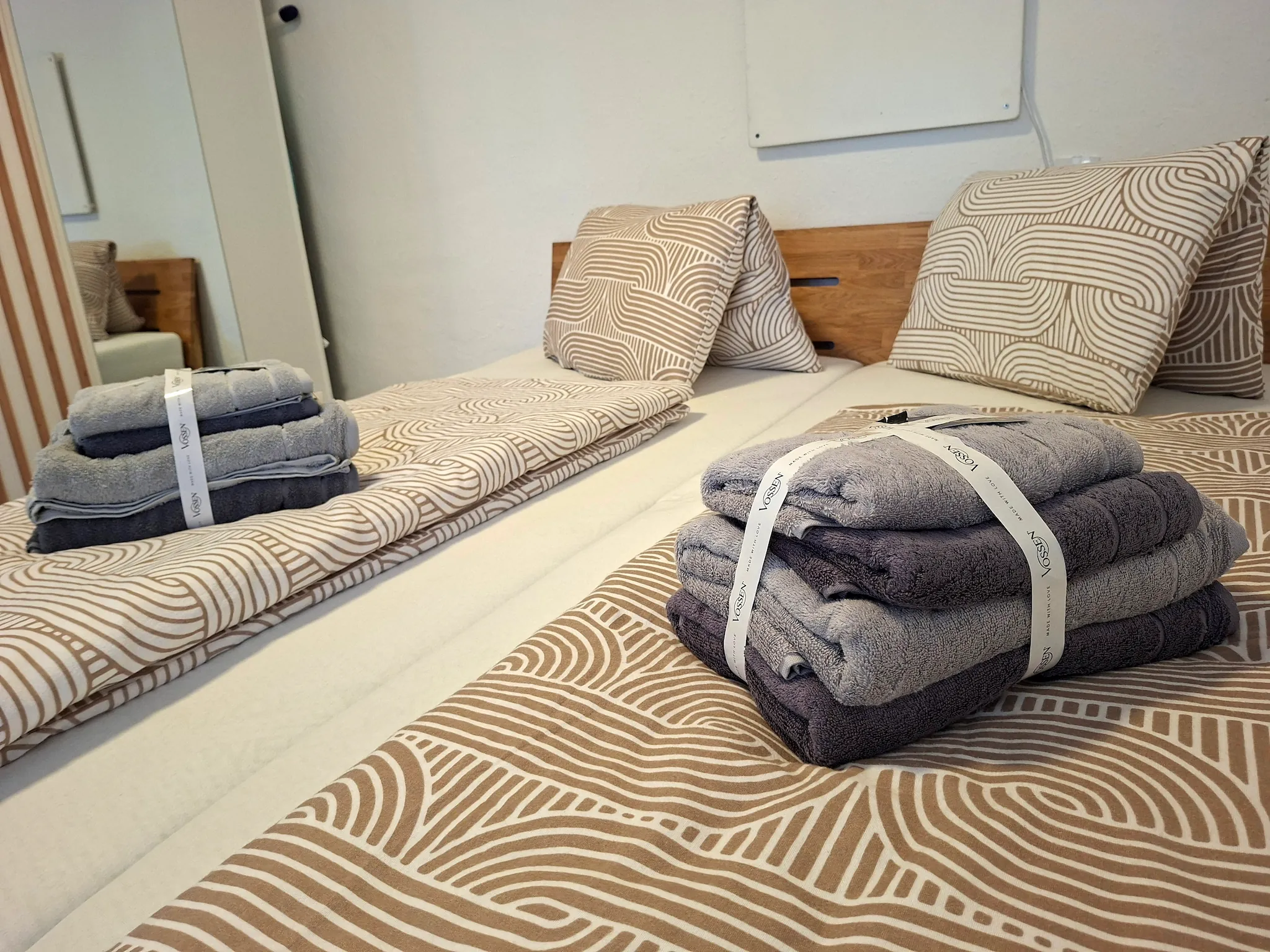 Minimalist living space with low modern furniture, large floor-to-ceiling windows, soft natural light, and an open view of a calm outdoor landscape.