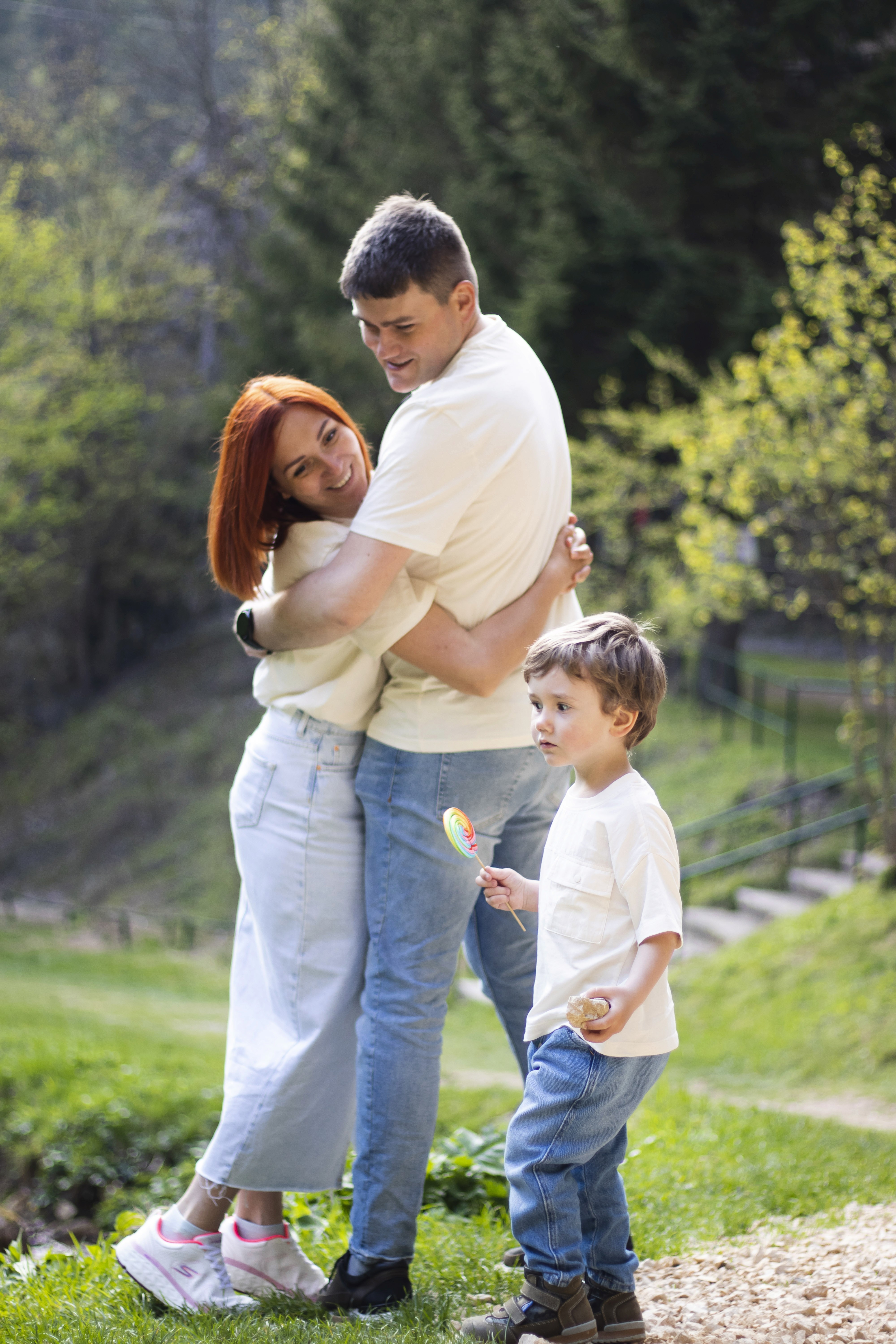 man in white shirt carrying girl in gray shirt