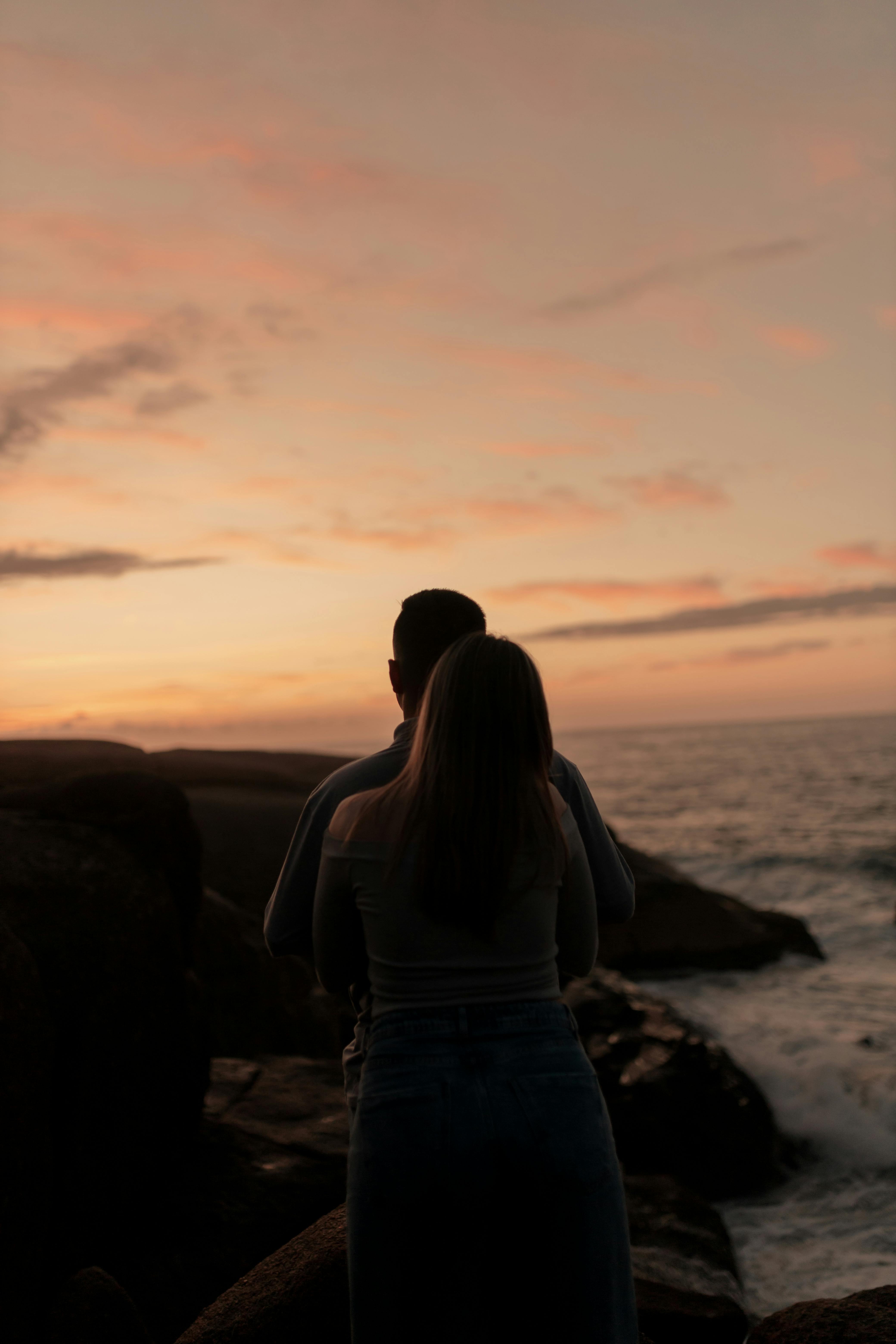 A man and a woman hugging on the beach