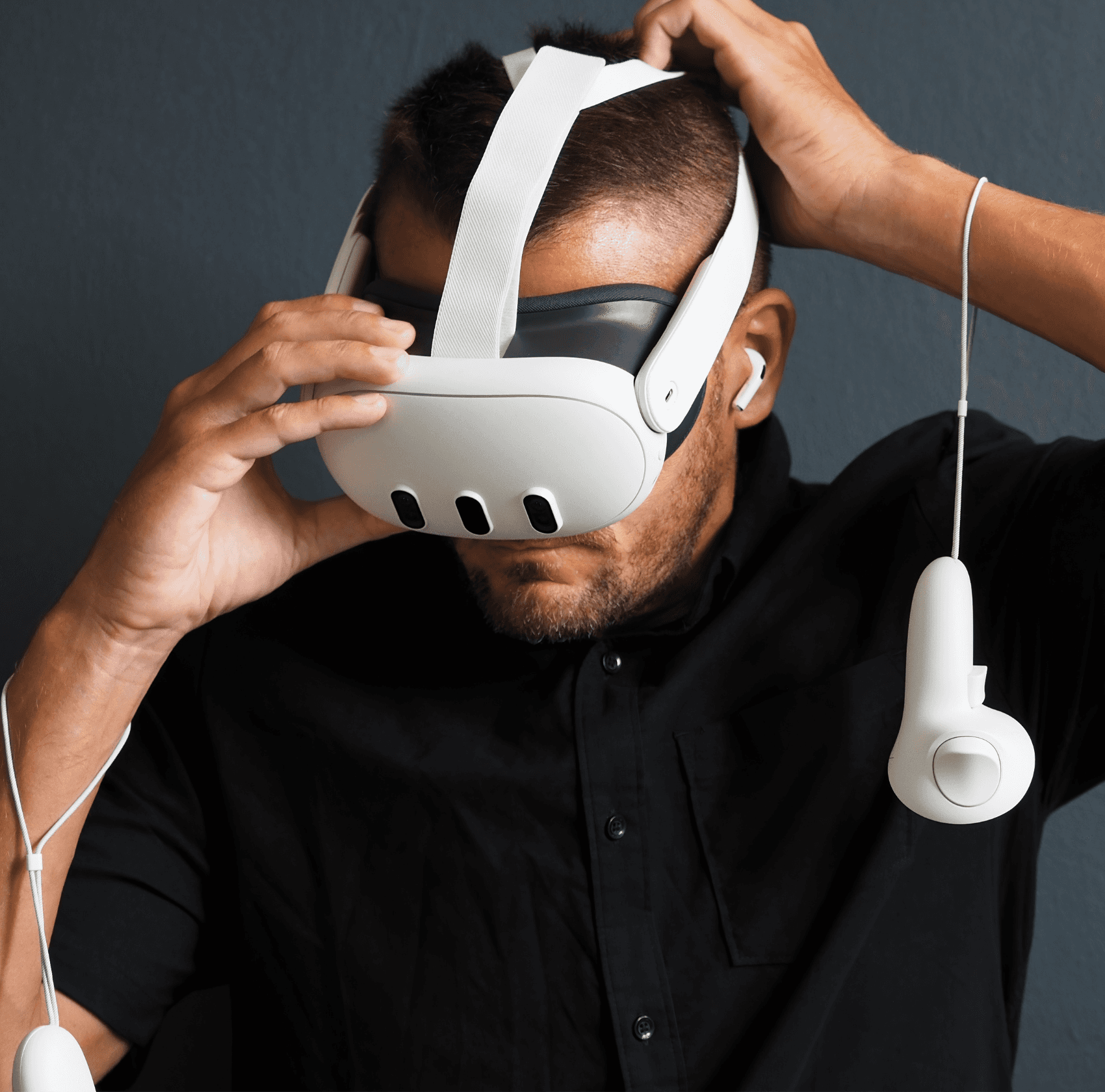 Bald man putting on a Meta Quest 3 mixed reality headset