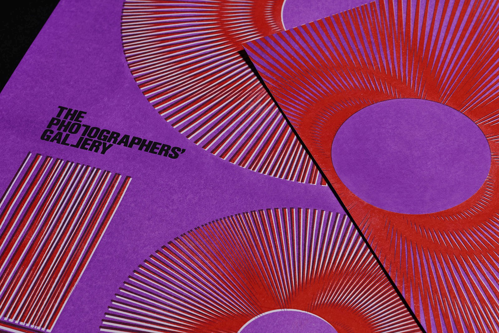 Abstract patterned background with vibrant red and purple swirls, featuring a small metallic object in the foreground.