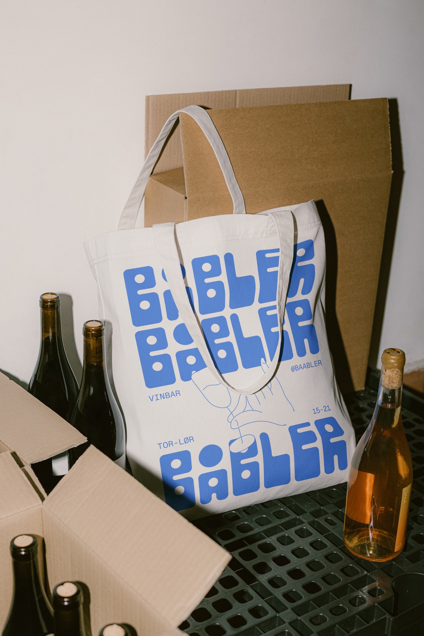 A tote bag designed for Båbler standing in a wine storage.