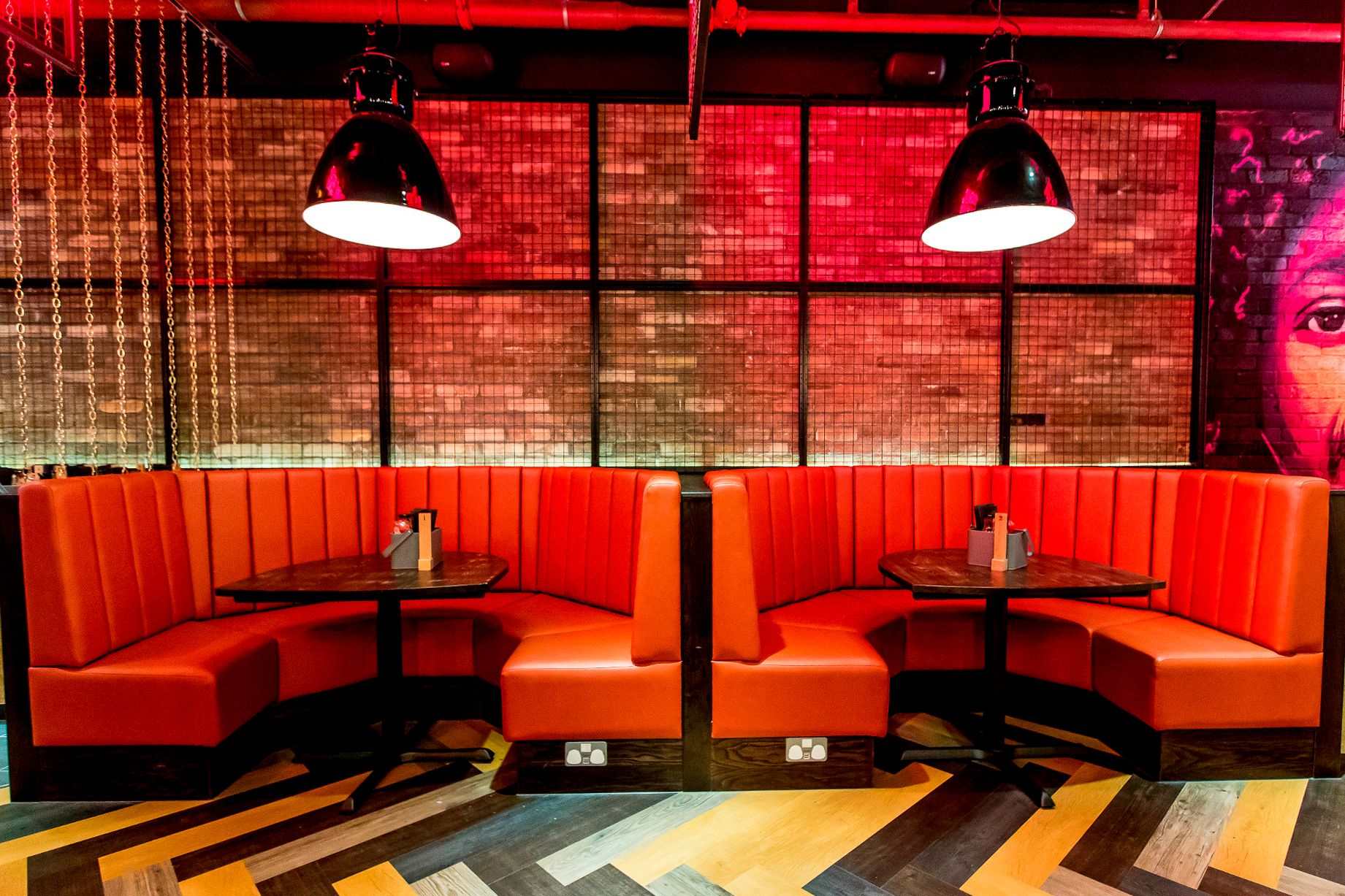 Holy Moly Macaroni booth seating area with exposed brick finishes, pendant lighting and hospitality fit-out works delivered by Matrix IDC