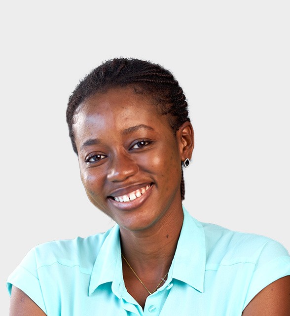 Smiling young woman in a turquoise shirt against a light background.