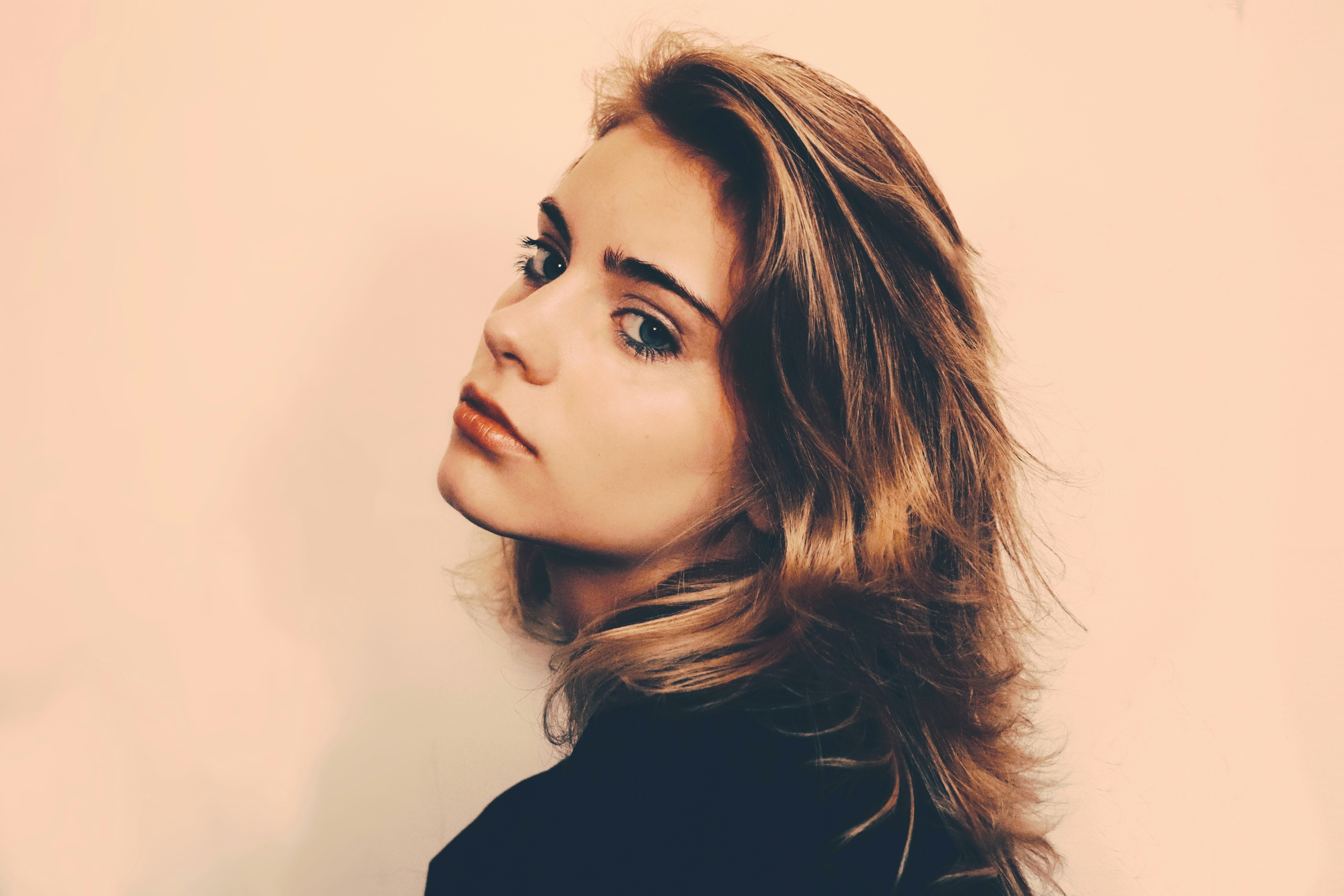 a woman with long hair and a black shirt