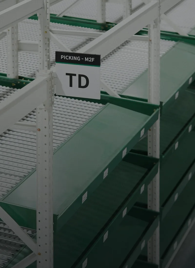 Green steel shelving in a warehouse