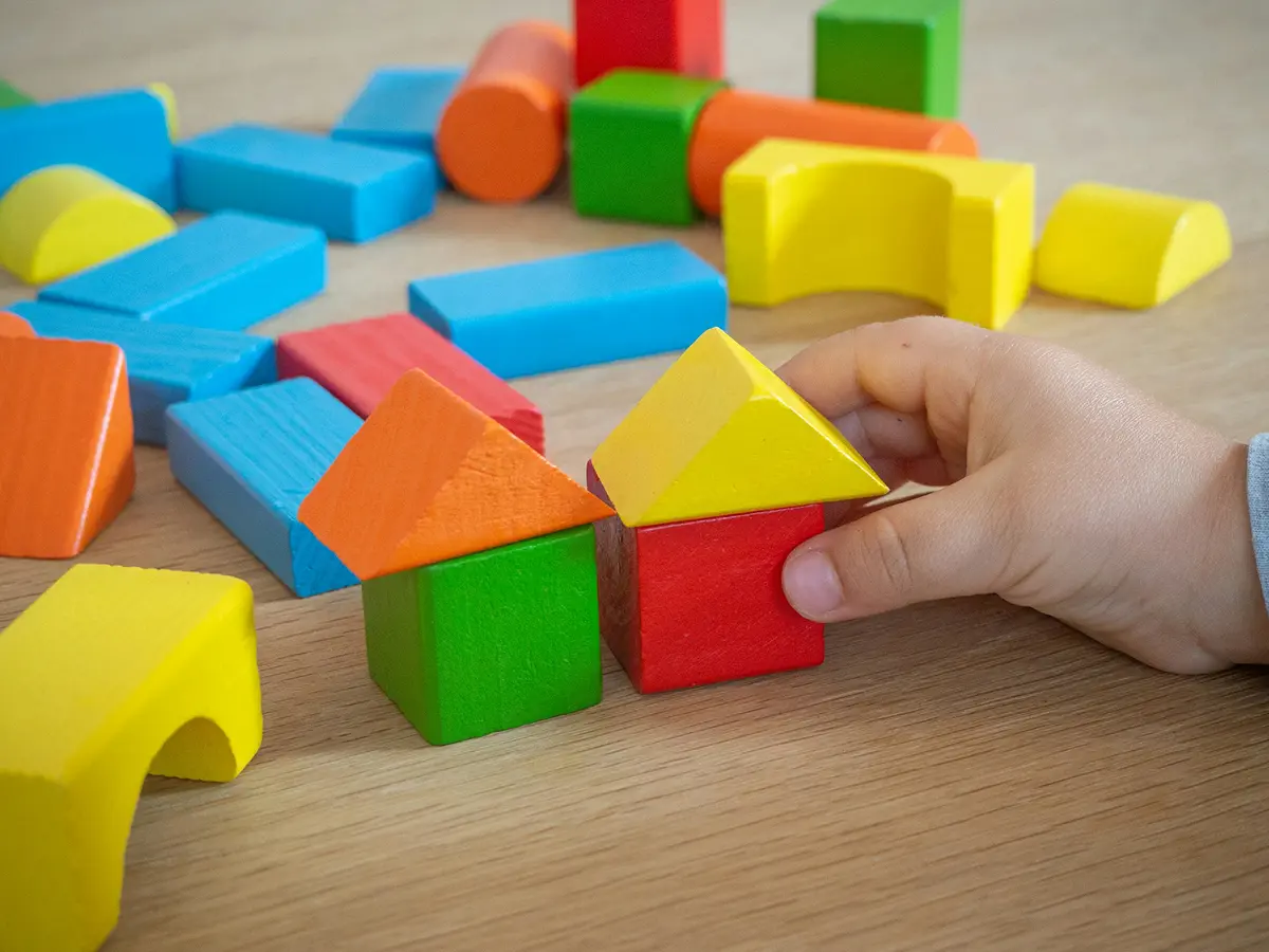 Staff disinfecting classroom surfaces and toys with child-safe cleaning products