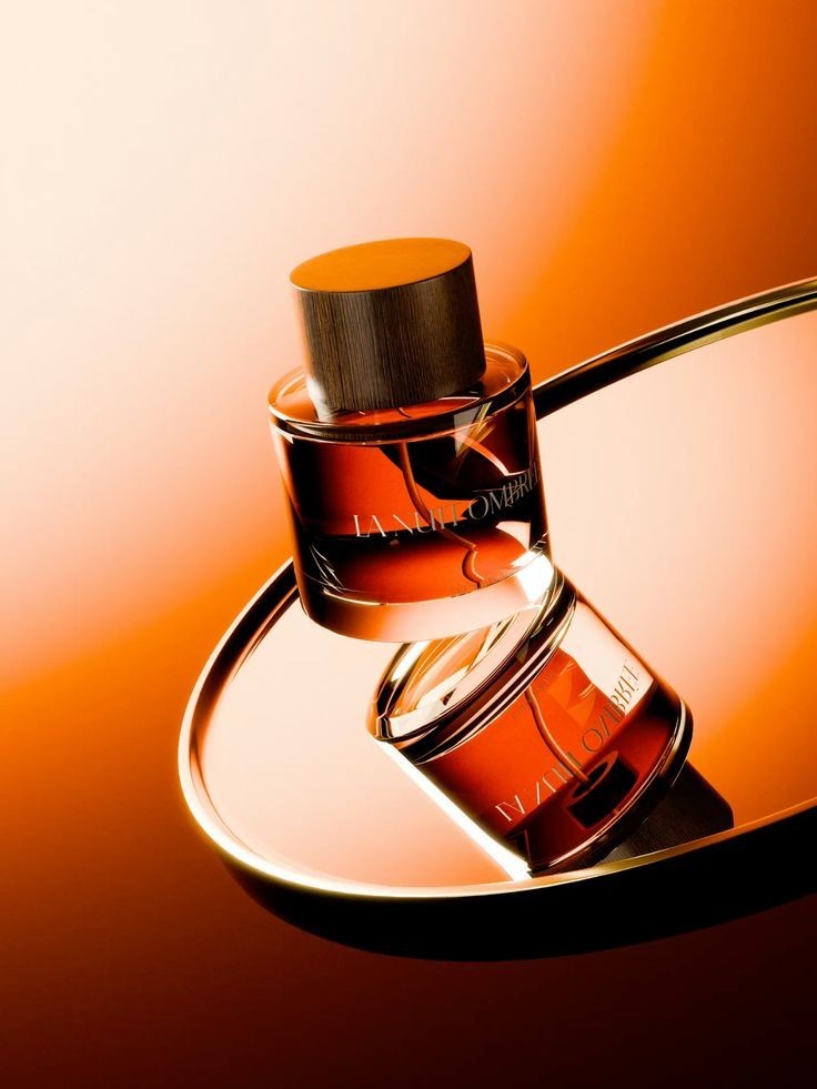 Amber perfume bottle on an orange backdrop