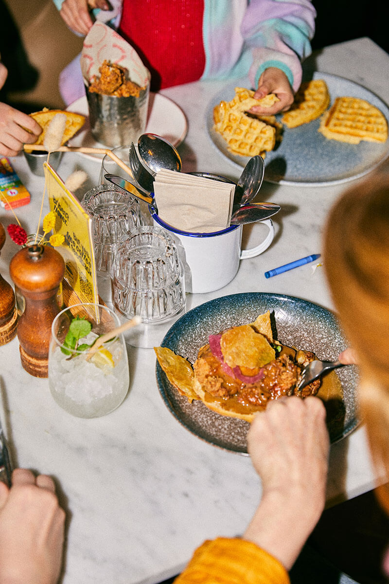 People sitting around the table and eating fried chicken meals