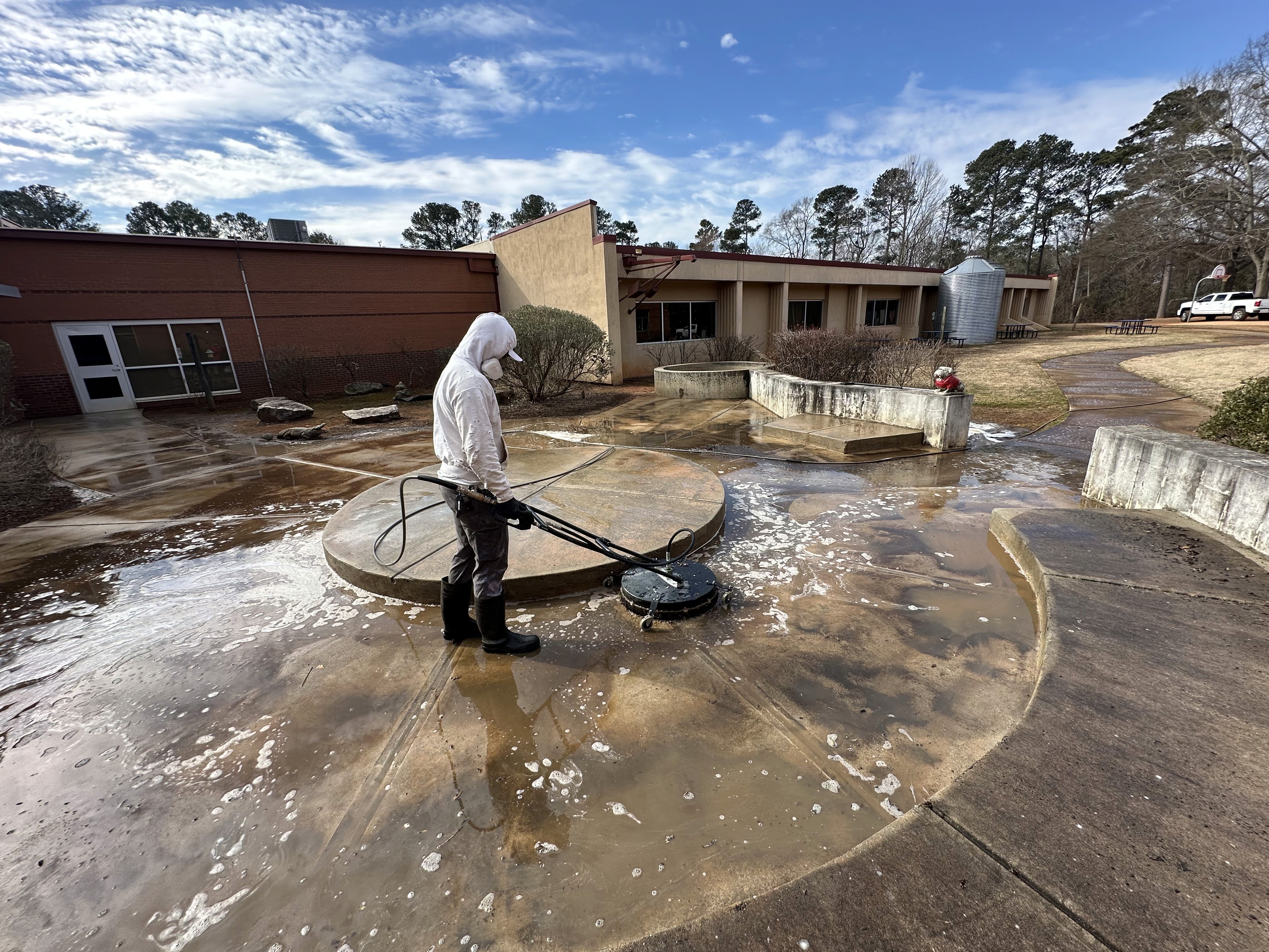 a man in a yellow vest is cleaning a street