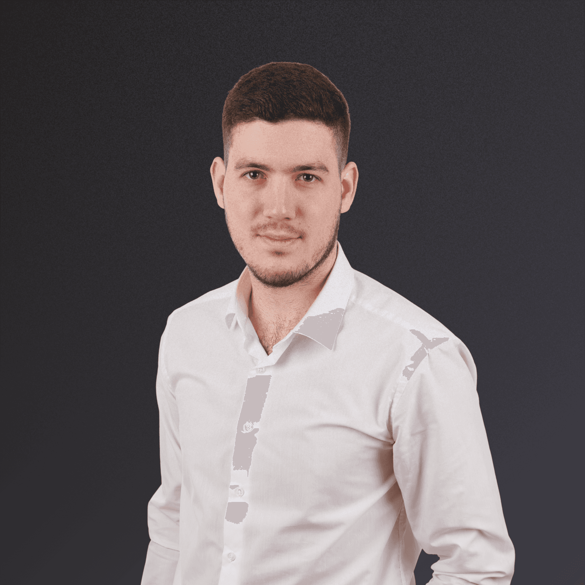 Woman with a short haircut smiling confidently, wearing a blazer and standing in warm natural light with modern architecture behind her.