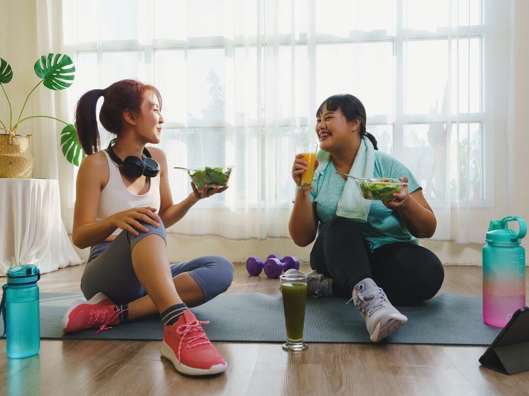 two friends having a healthy meal together after working out to lose weight cycling