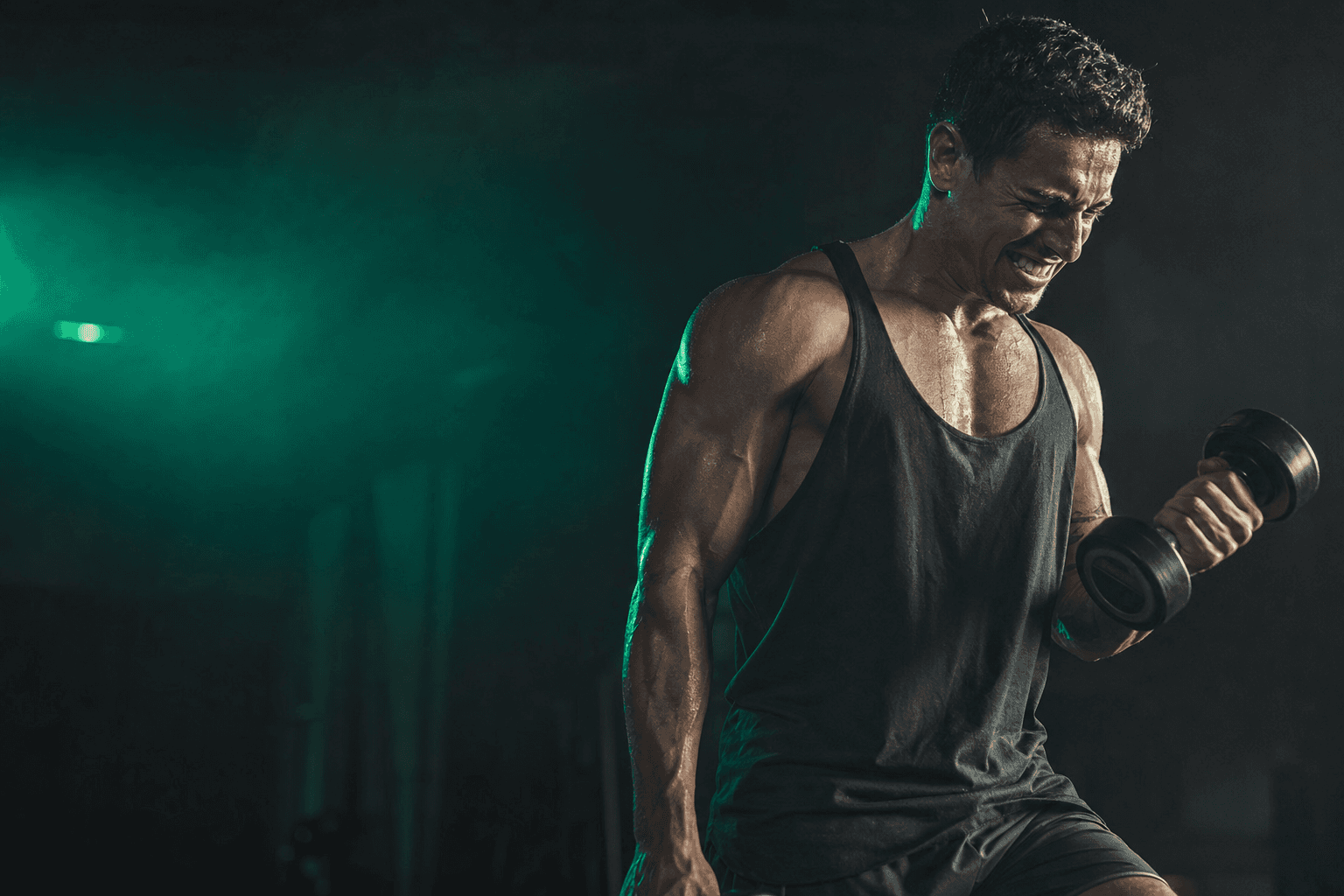 Athlete straining through a high-rep set with a light dumbbell near muscular failure