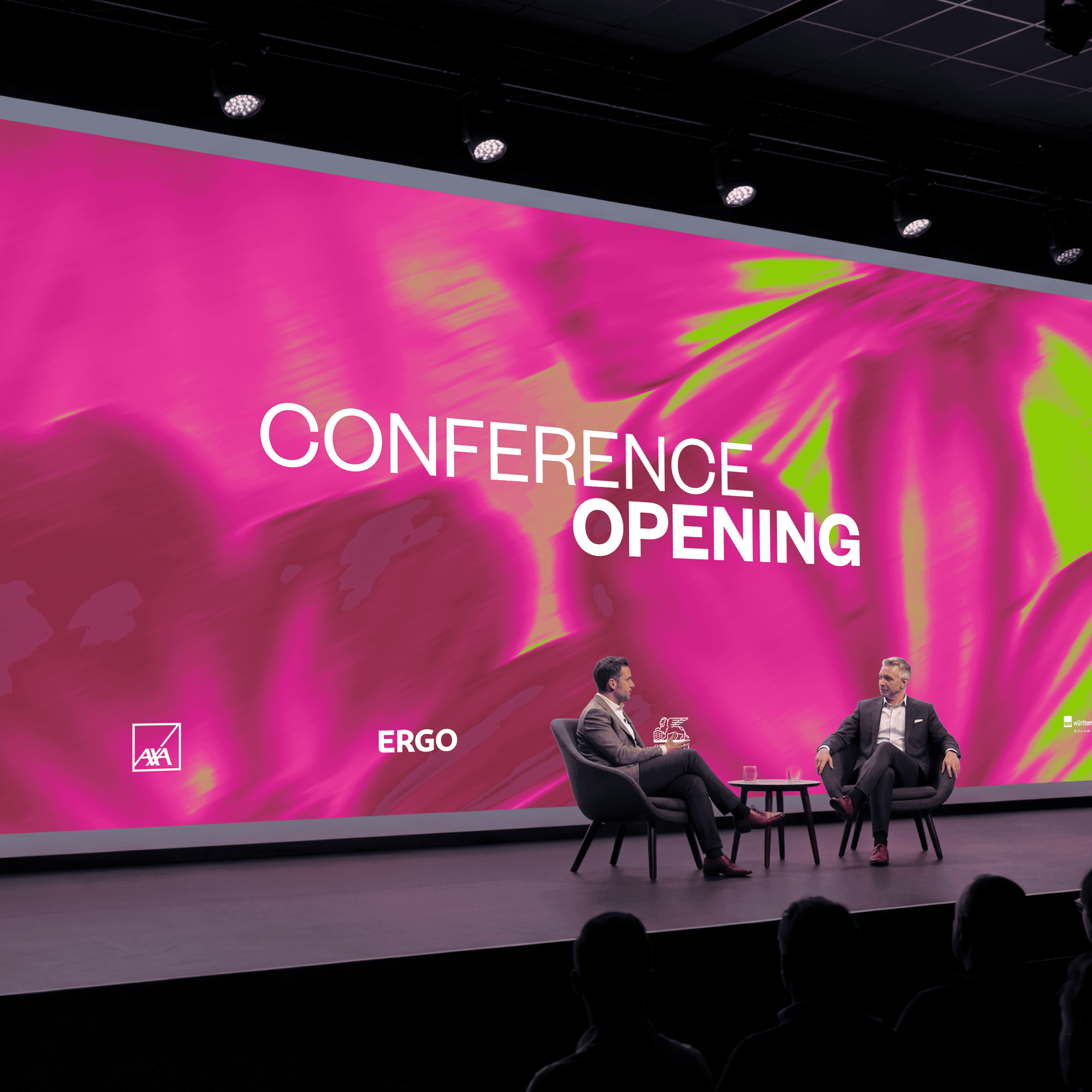 Large LED screen displaying the IDC 2026 visual identity in magenta and lime green, with "Conference Opening" on stage during a live panel event