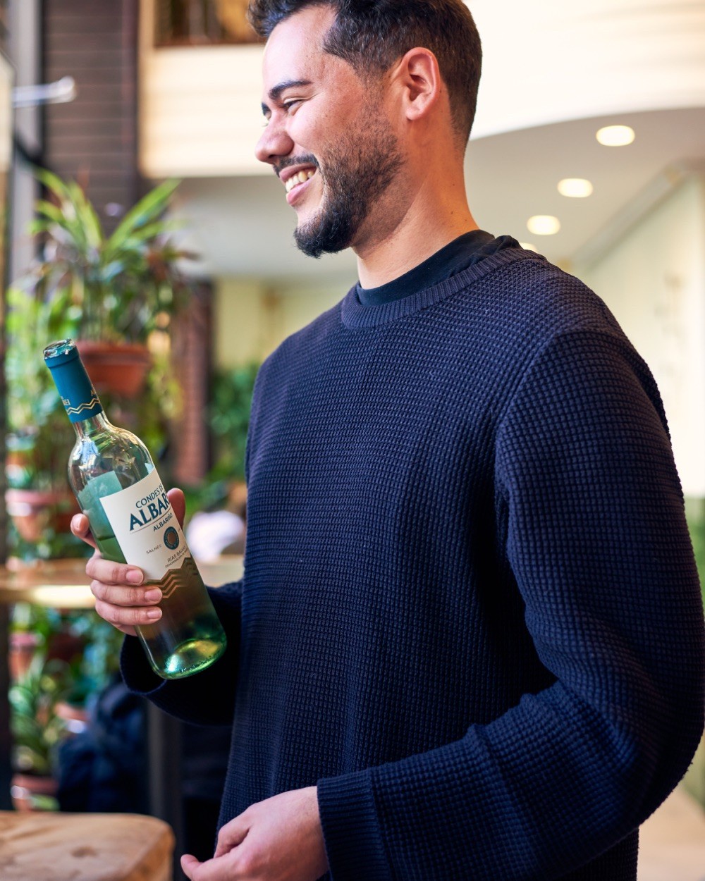 Sommelier presenting a bottle of Spanish wine during a Barcelona wine tasting experience.