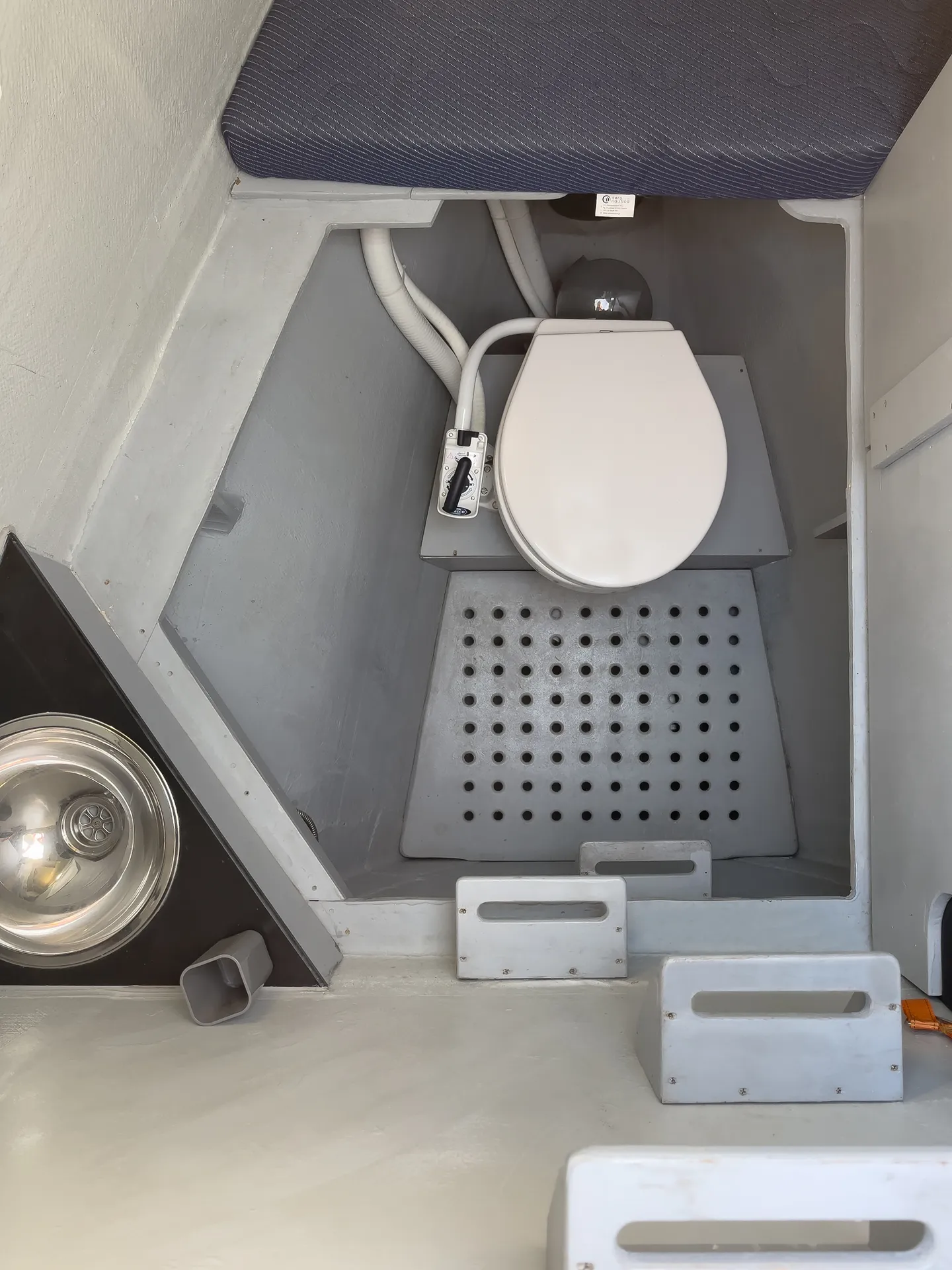 White Rock 36 speedboat with captain at helm cruising calm blue waters near Paros coastline with hills in background.