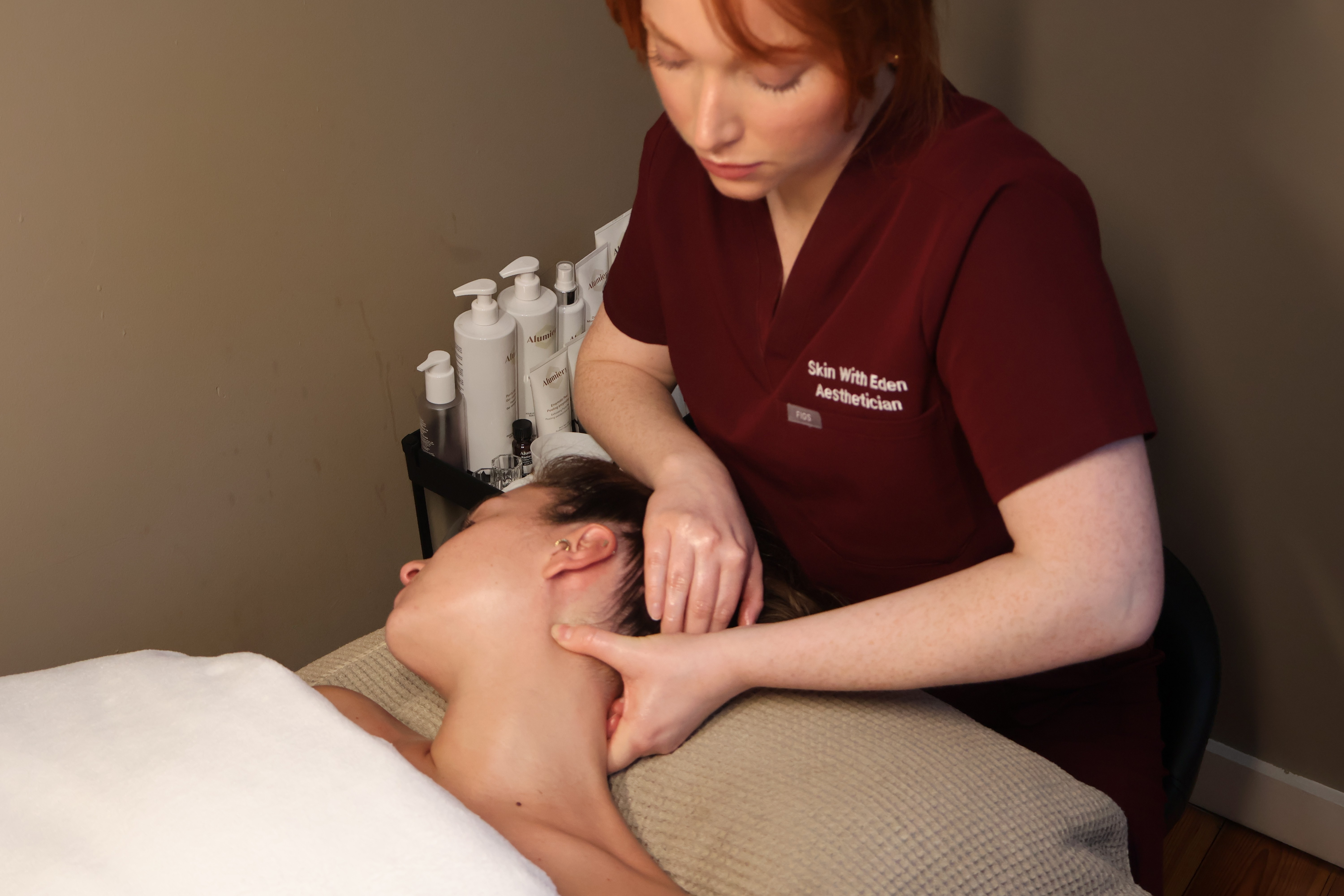 Rachel, personal trainer, looking to the side confidently in a fitness studio