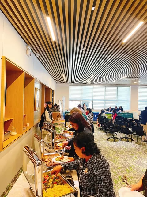 Close-up of a dark green leaf showing its textured surface and central vein against a muted background.