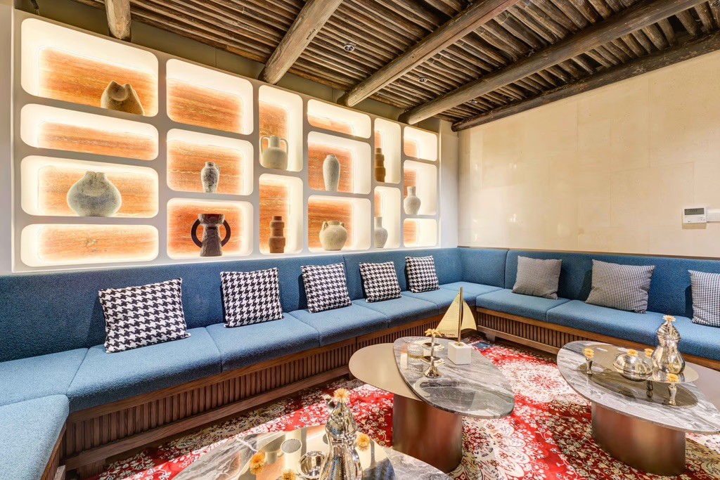 Executive boardroom featuring a large screen, comfortable seating, and wood paneling.