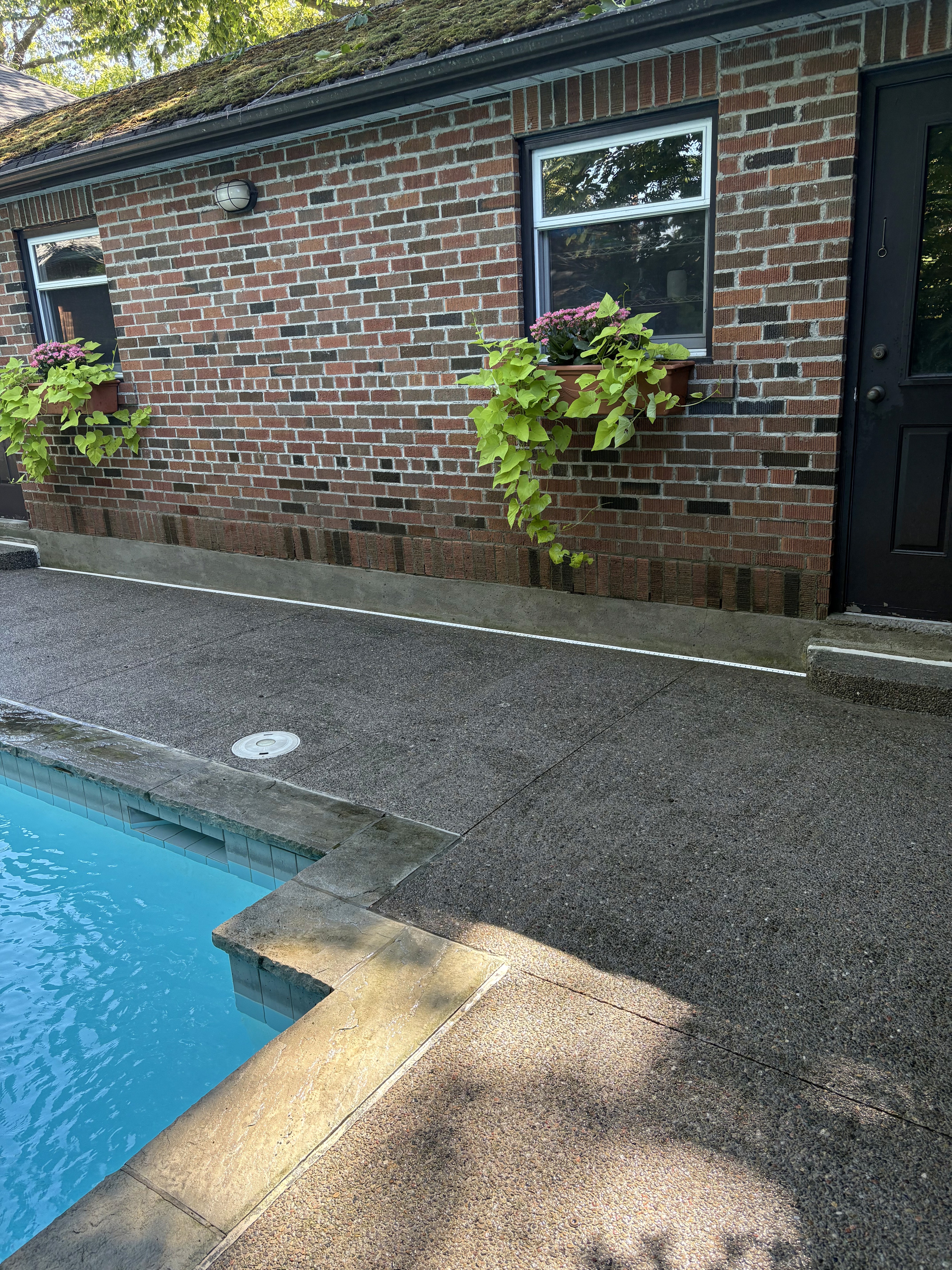 Pool deck pavers freshly pressure-washed at a Toronto home