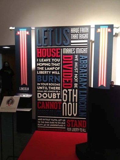 typographic billboard with vertical and horizontal text in blue, white, and red