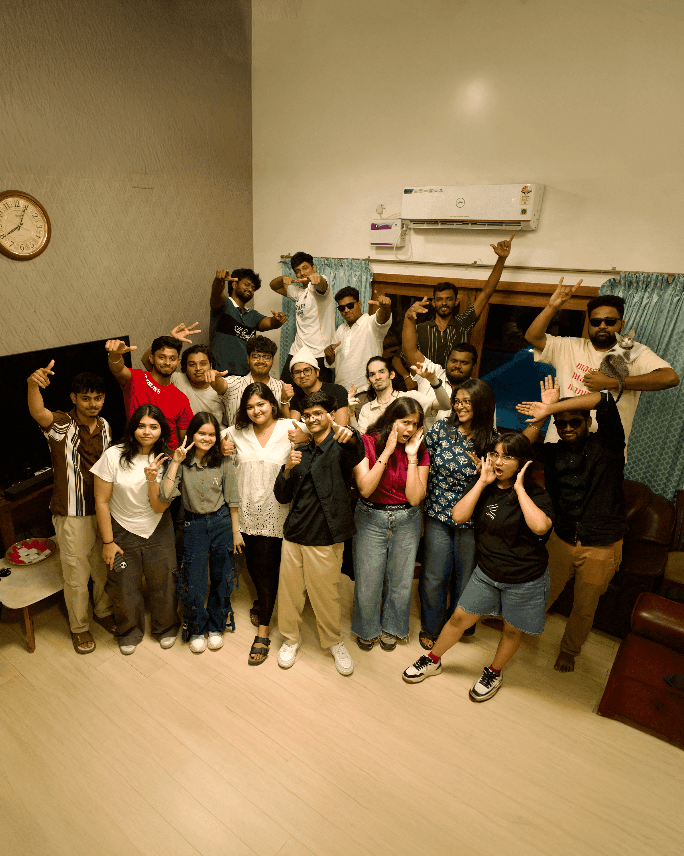 Three people sitting on a couch in a room looking at mobile devices