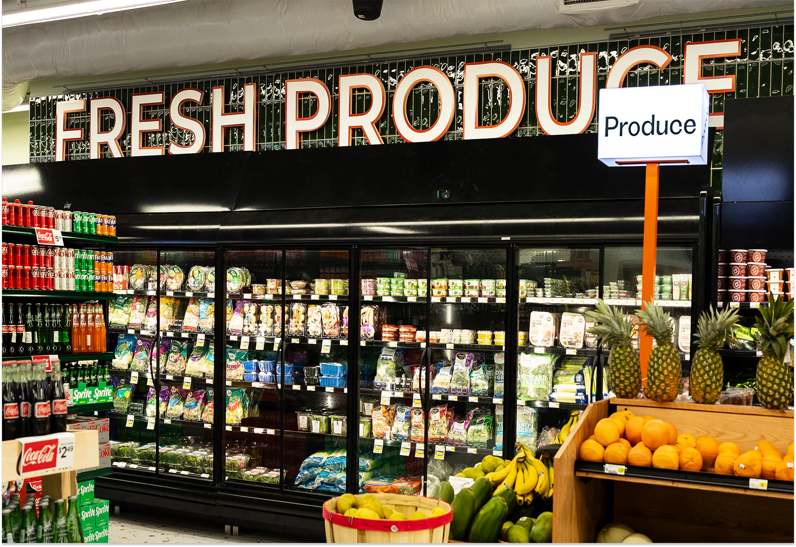 Final built interior of Azalea Market, showcasing the produce zone as a visible anchor for freshness, access, and everyday food needs in downtown Atlanta.